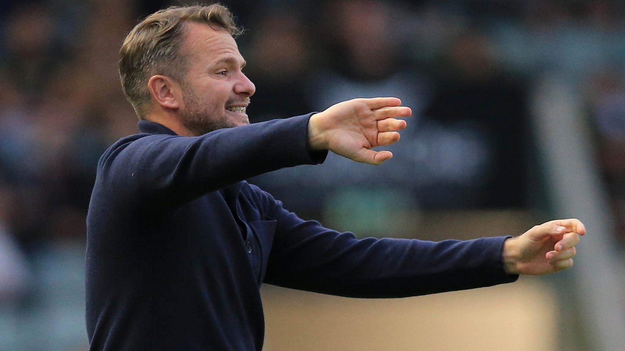 Tom Cleverley standing pitch side during Plymouth Argyle's match against Coventry City.