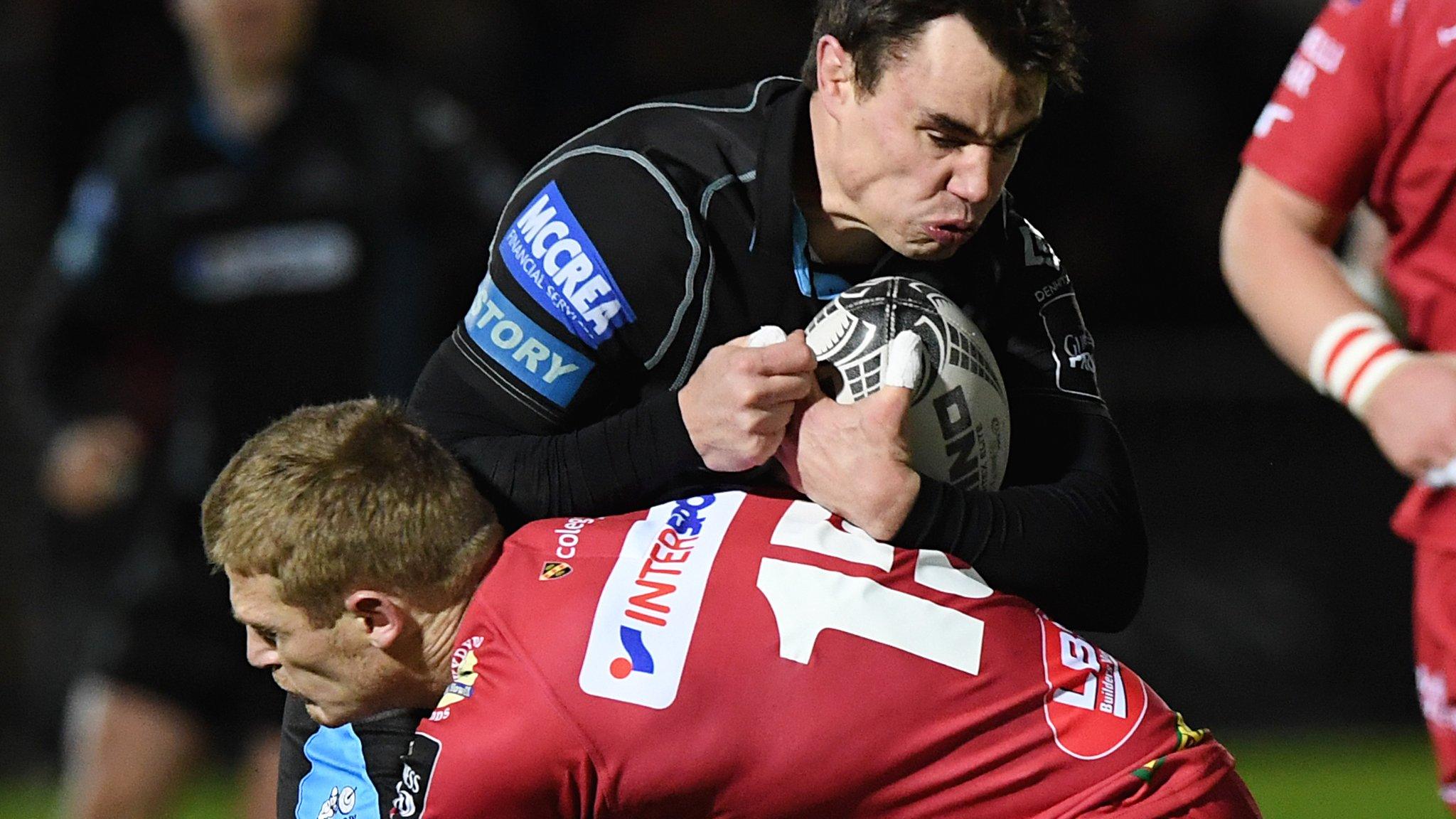 Glasgow Warriors' Lee Jones rides a tackle from Scarlets' Johnny McNicholl