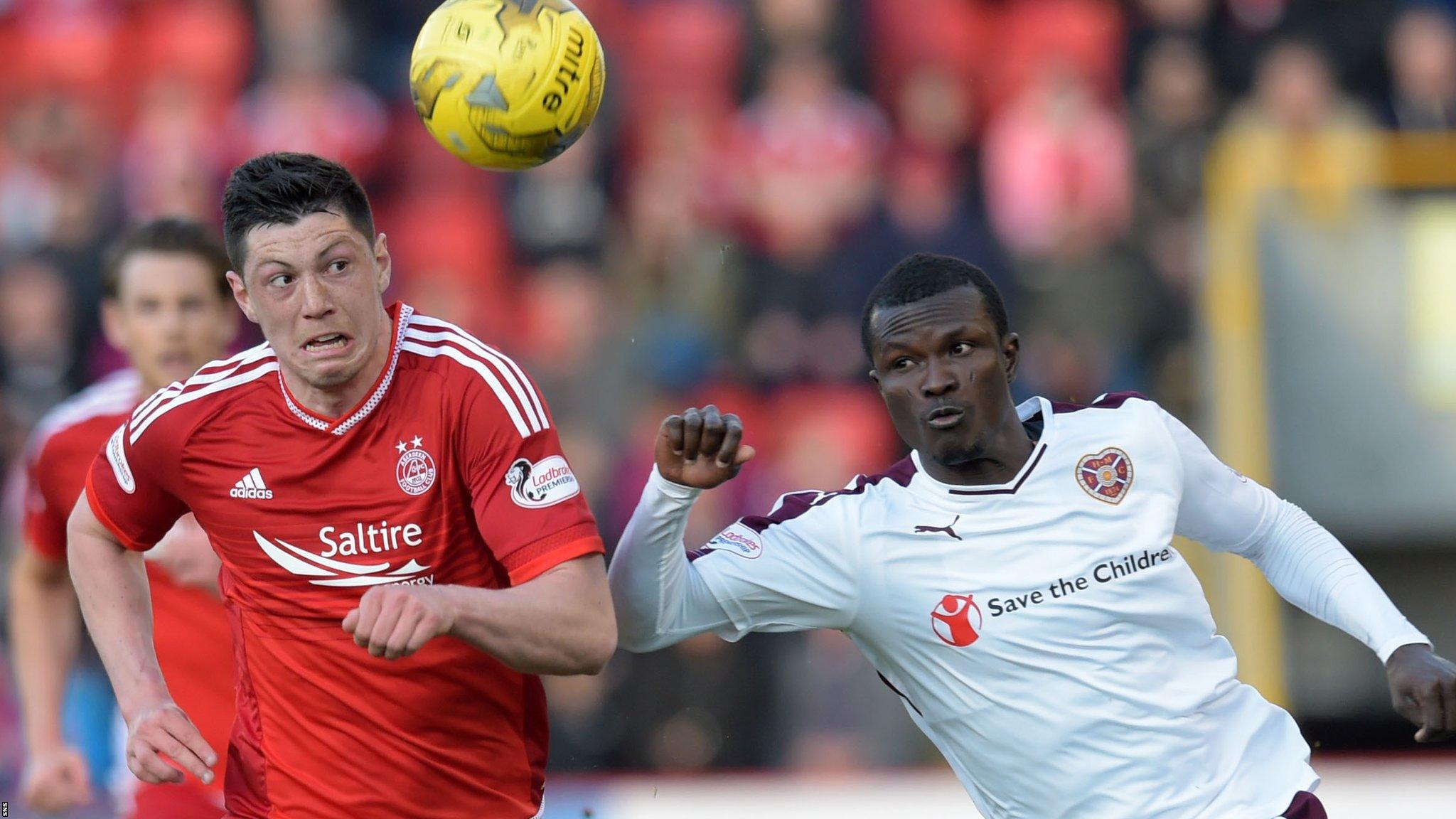 Aberdeen's Scott McKenna (left) and Hearts' Abiola Dauda challenge for the ball