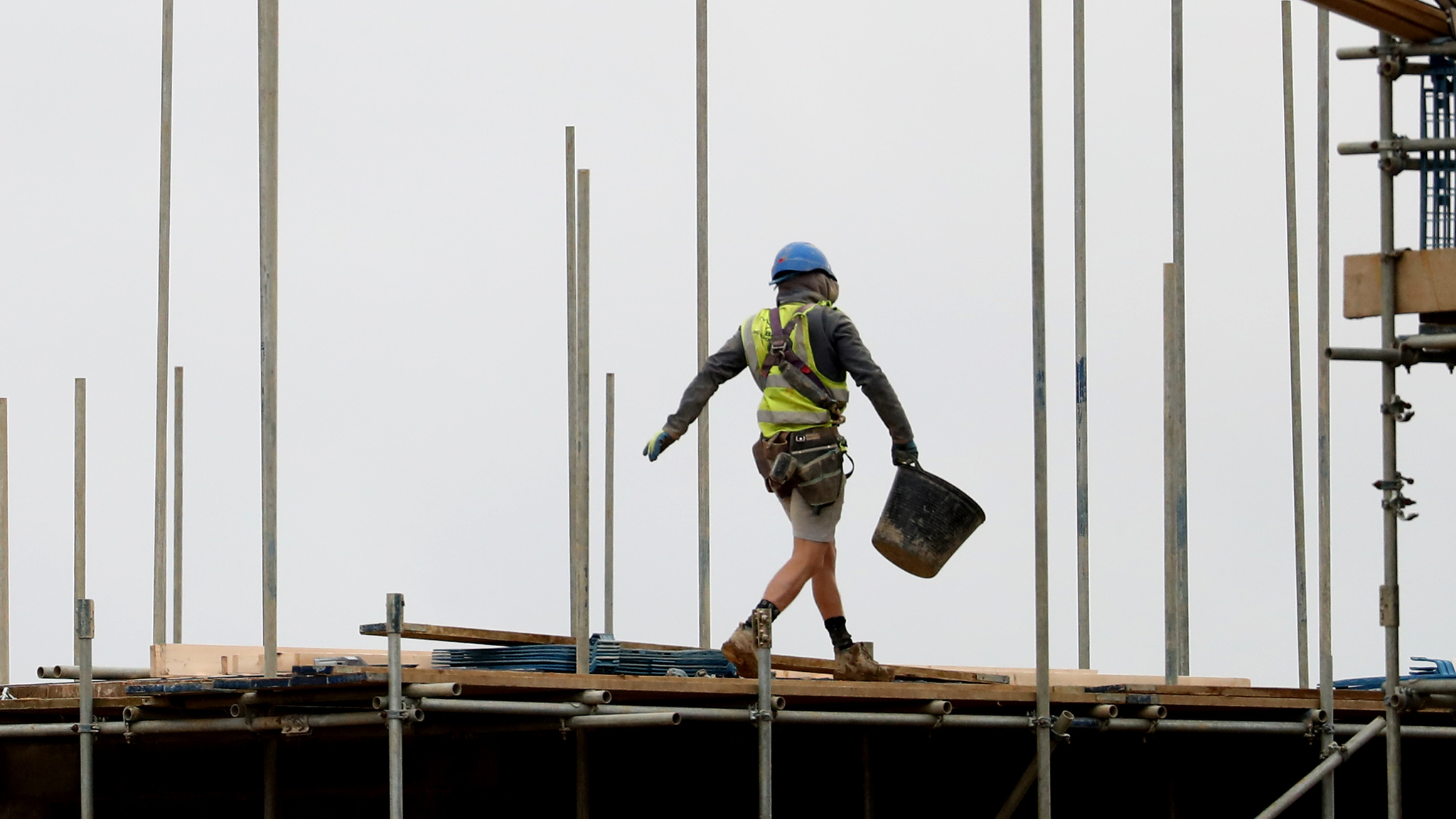 A builder on a roof
