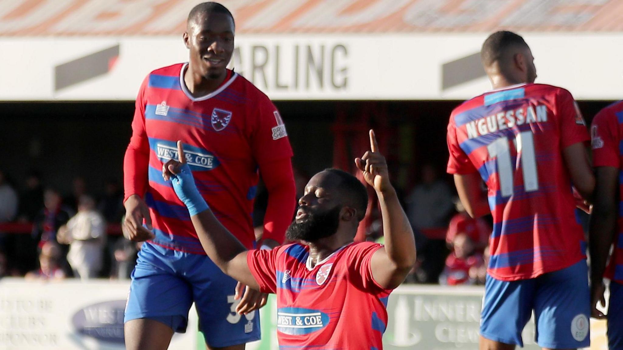 Dagenham & Redbridge players celebrate scoring a goal