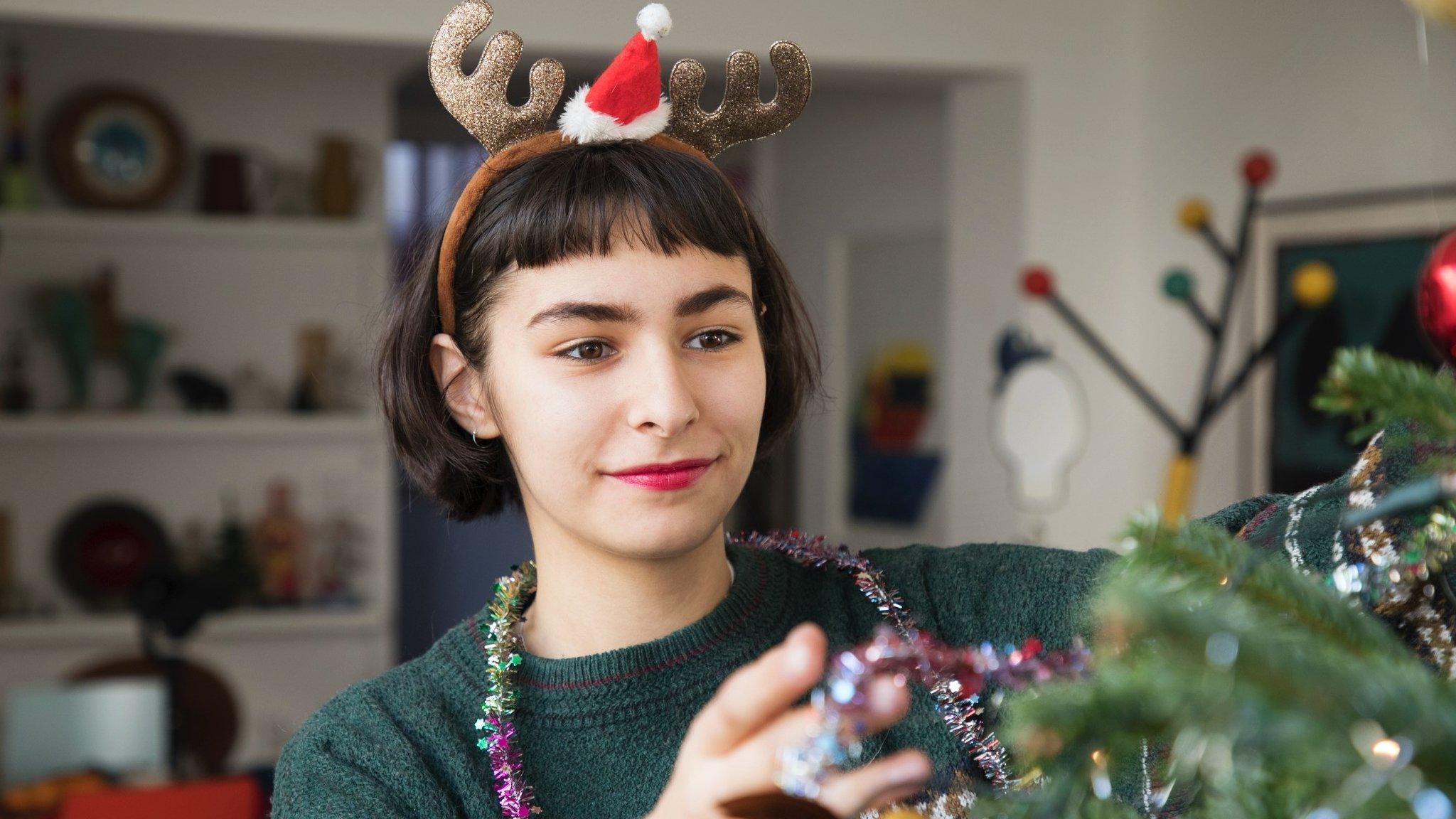 Woman decorating Christmas tree