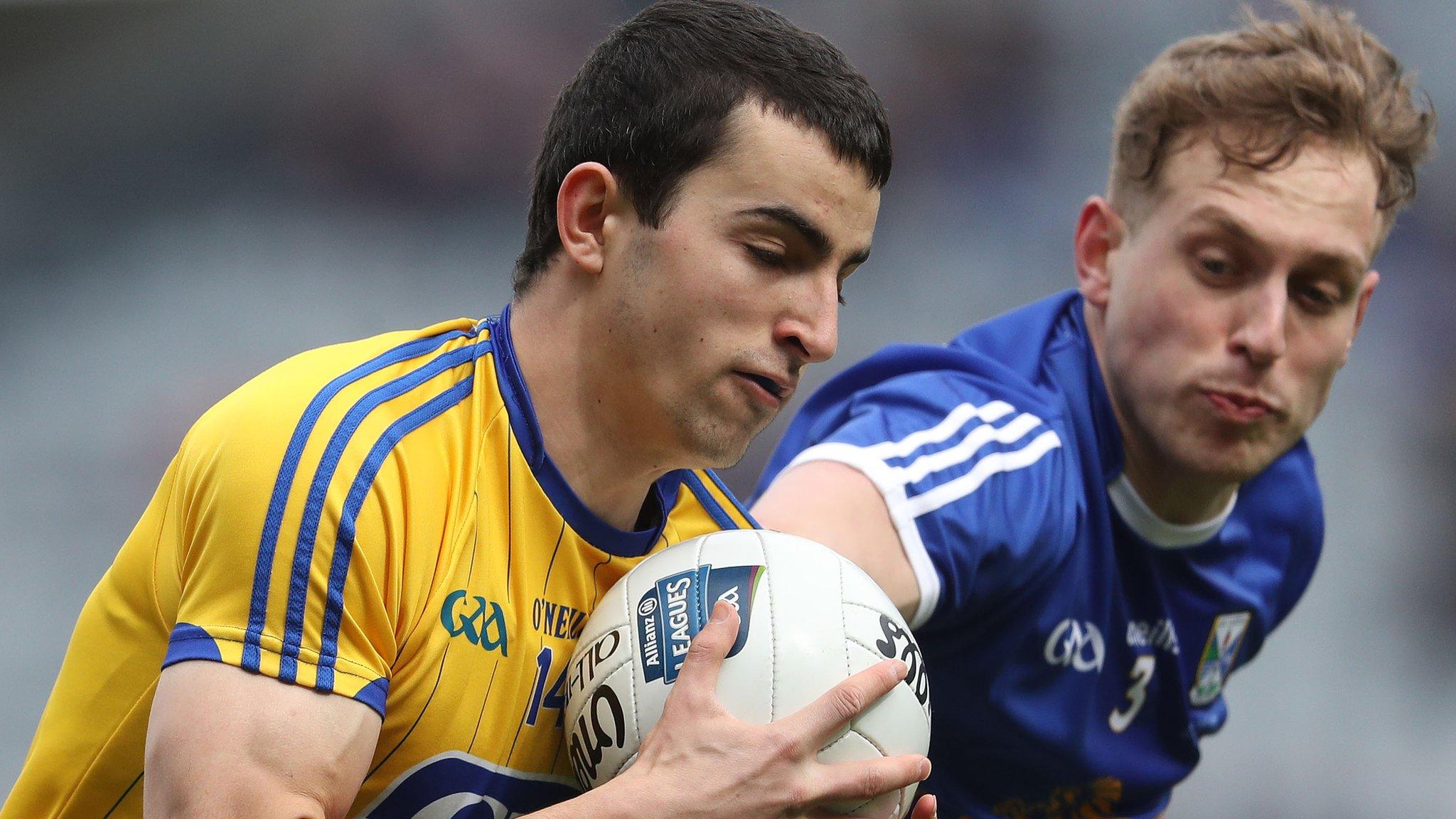 Roscommon's Ciaran Lennon is challenged by Cavan defender Padraig Faulkner