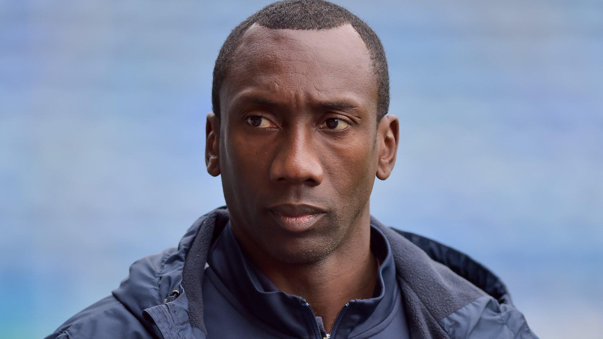 Jimmy Floyd Hasselbaink watches on