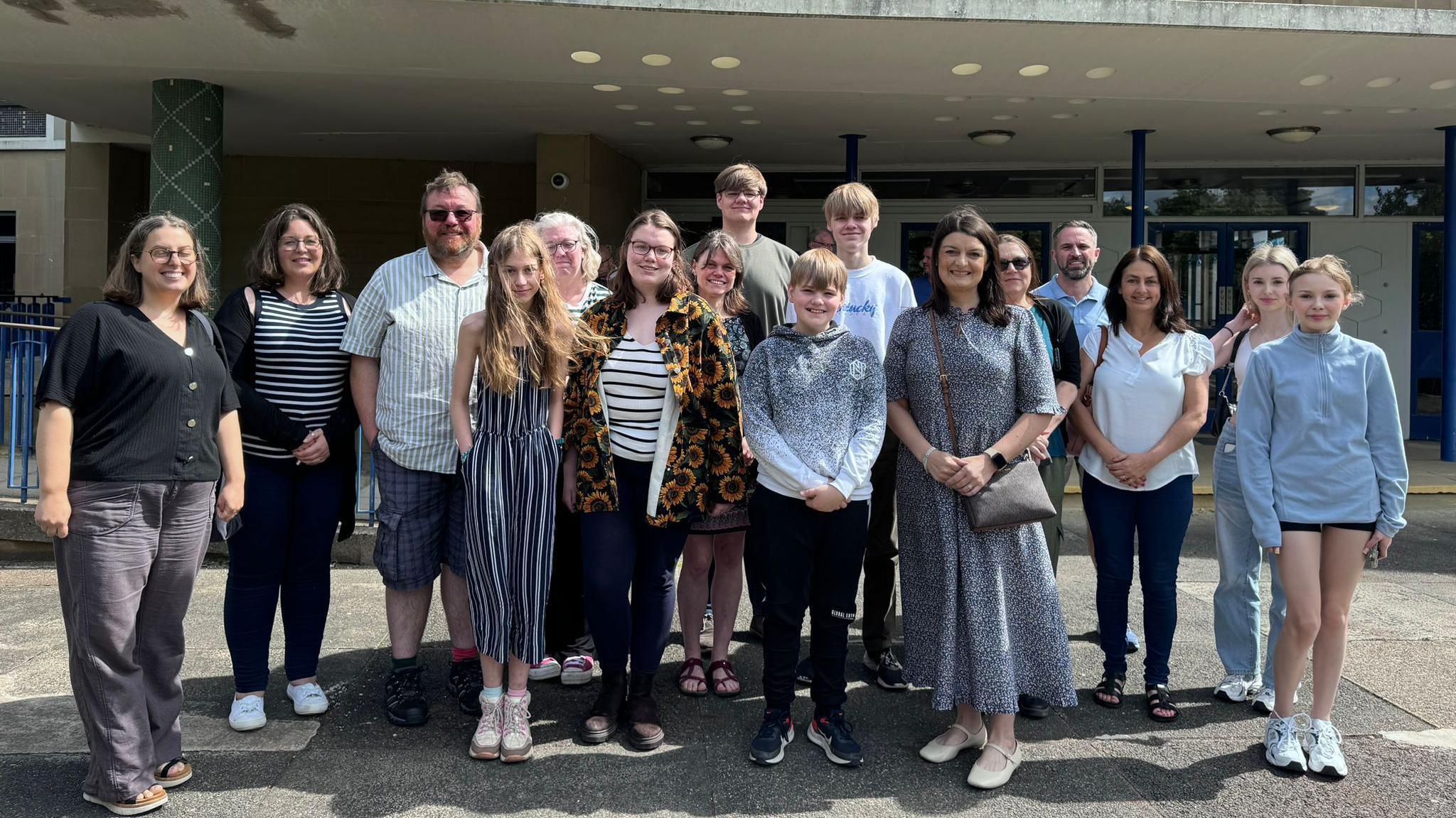 Smiling parents and pupils standing outside Durham County Council's headquarters after the planning permission was approved