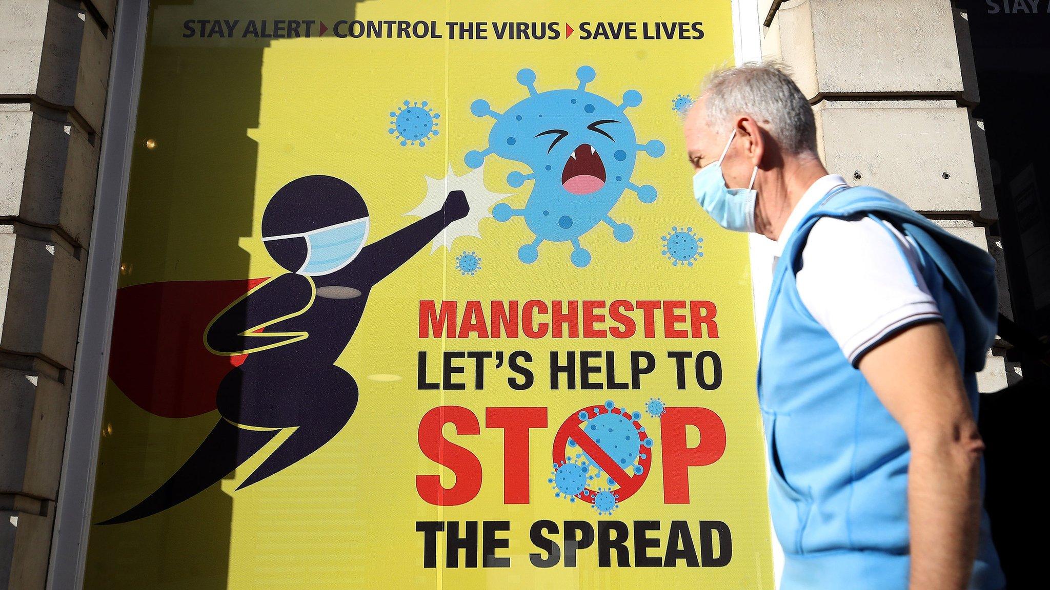 A man wearing a mask in Deansgate, Manchester