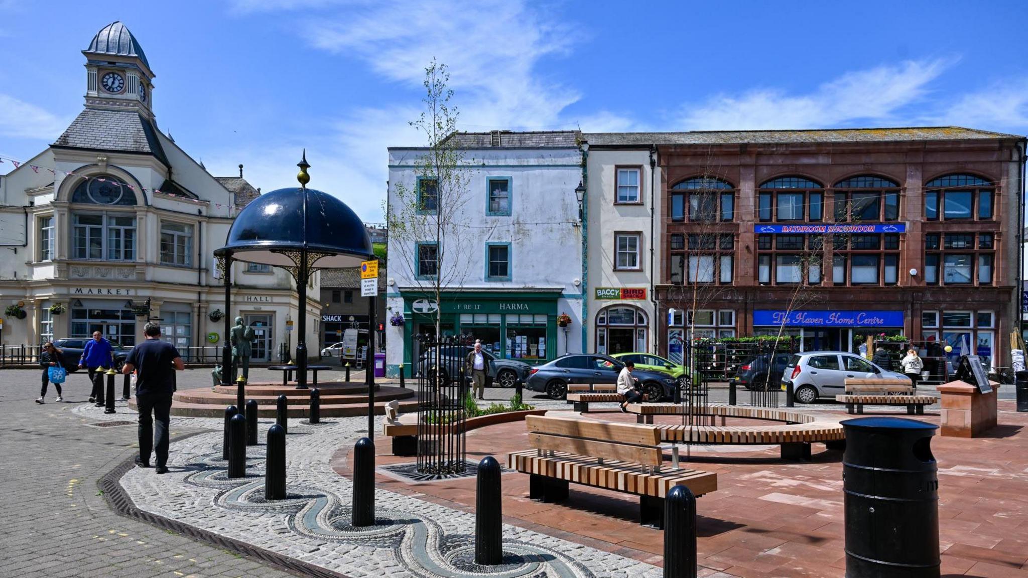 A general view of Green Market with new wooden seating, information boards and the memorial flagstones.