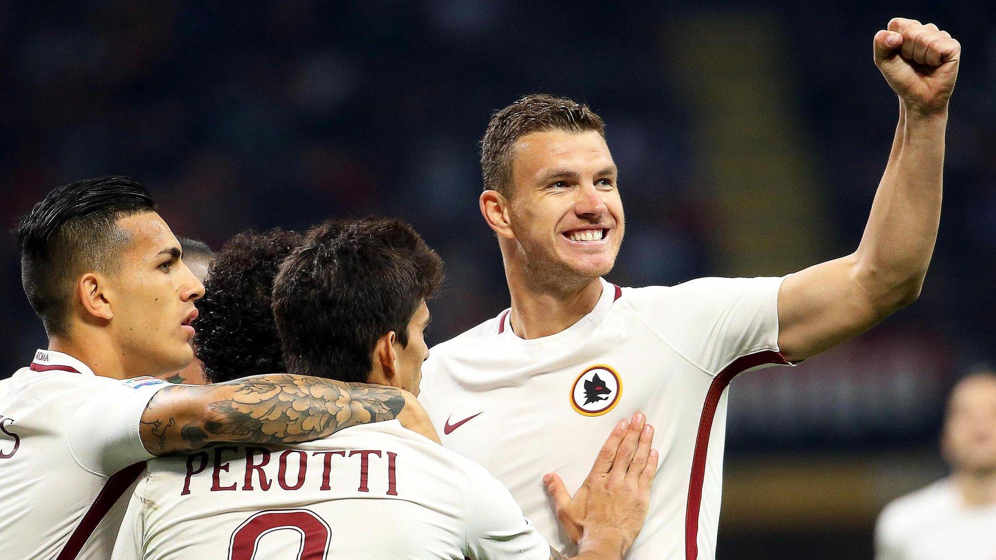 Edin Dzeko celebrates scoring for Roma away to AC Milan in Serie A