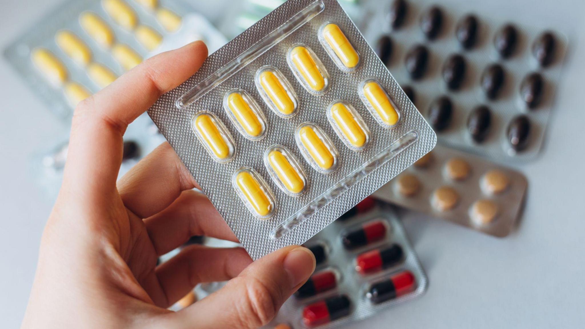 Person holding medication packets