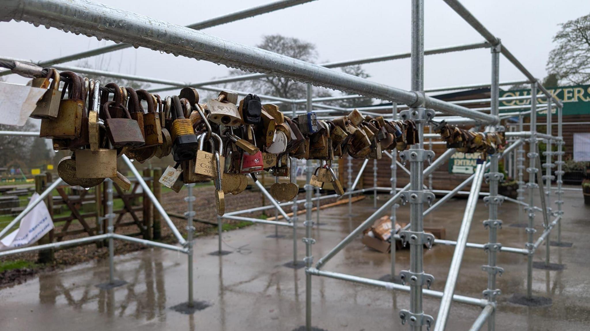 Padlocks strung up on the new Love Locker structure at Thornbridge Hall