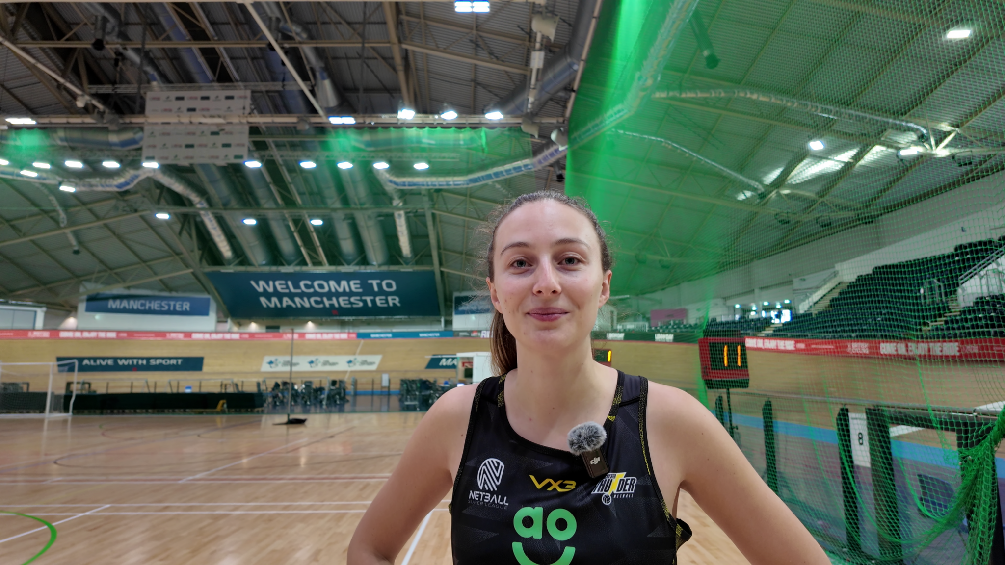 Amy Carter smiles at the camera. Her light brown hair is pulled back from her face and she is wearing her black Manchester Thunder sports dress.