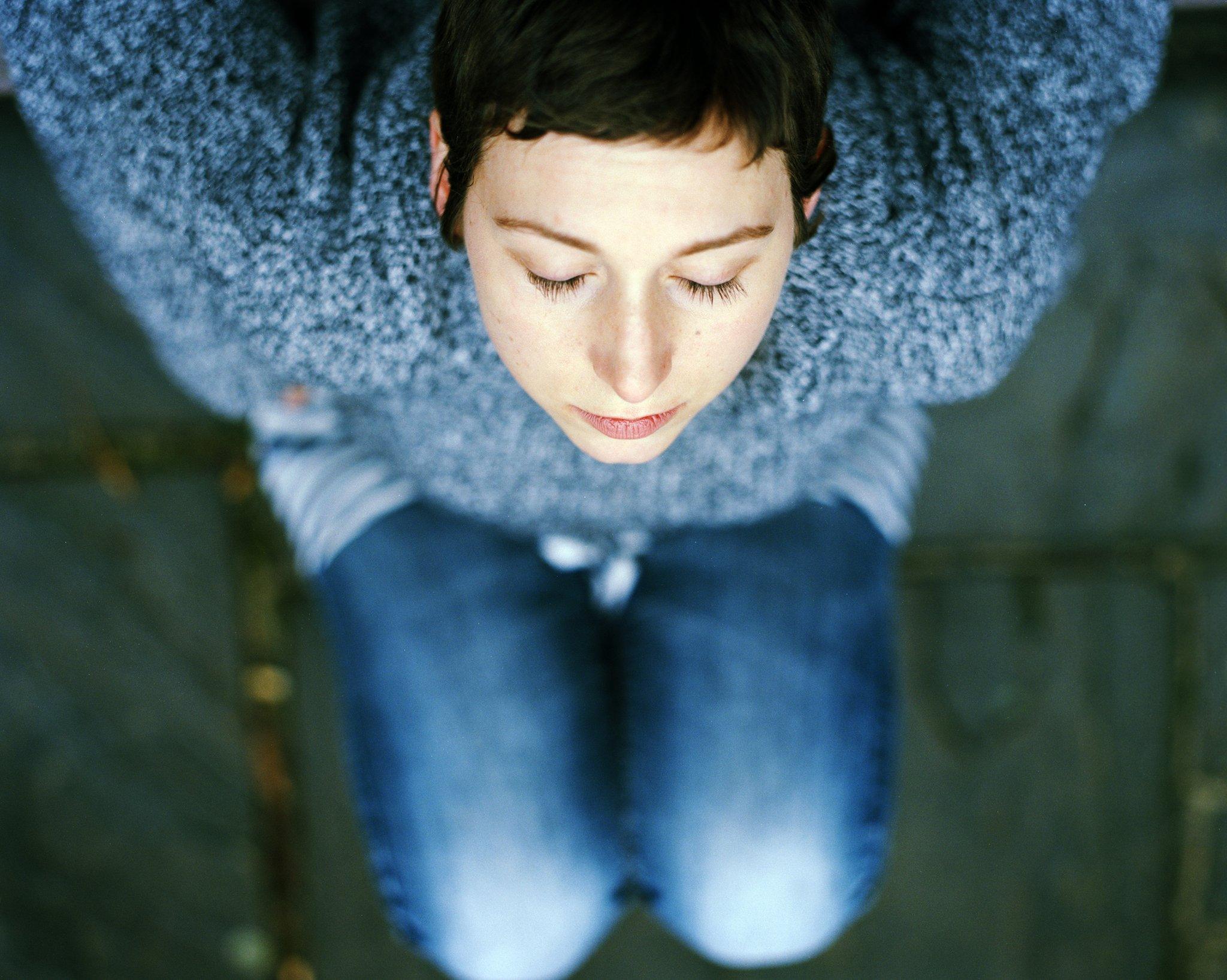 Photo shot from above of Carly Clarke relaxing with eyes closed, after her chemotherapy has finished