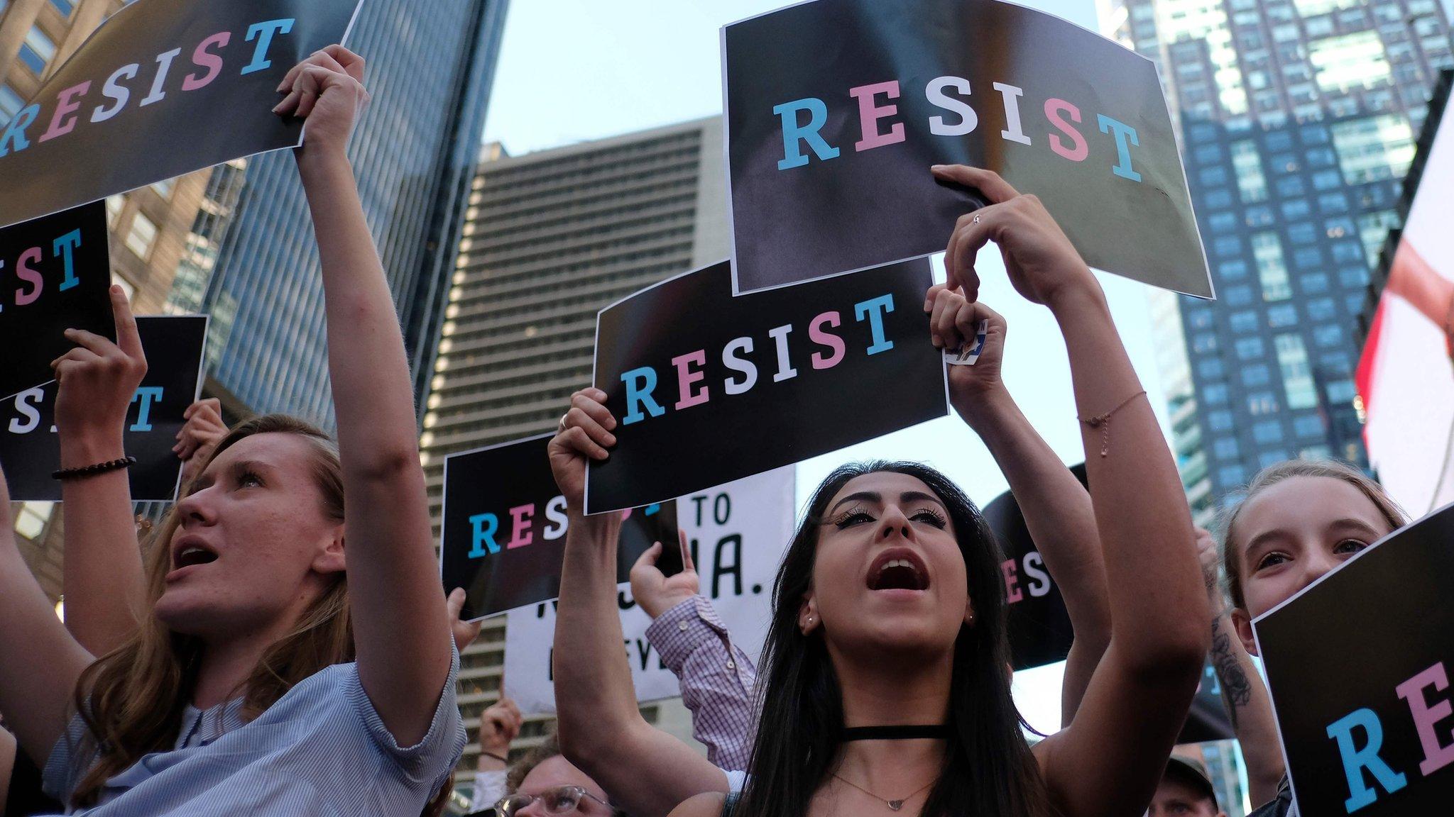 Protesters shout slogans against US President Donald Trump during a demonstration in front of the US Army career center in Times Square, New York, on July 26, 2017.