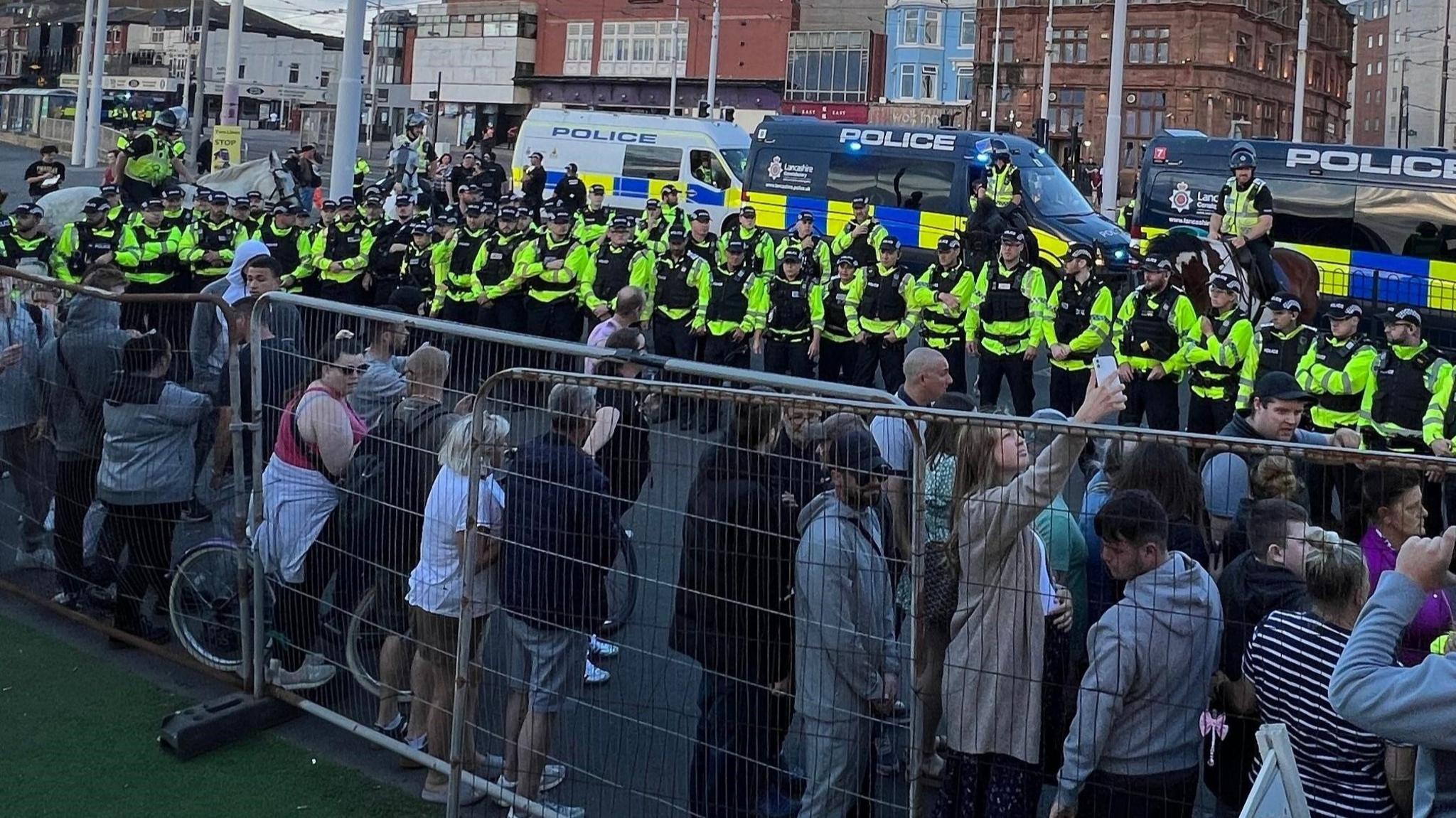 Police officers in Blackpool box in a group of protesters during the unrest on 3 August