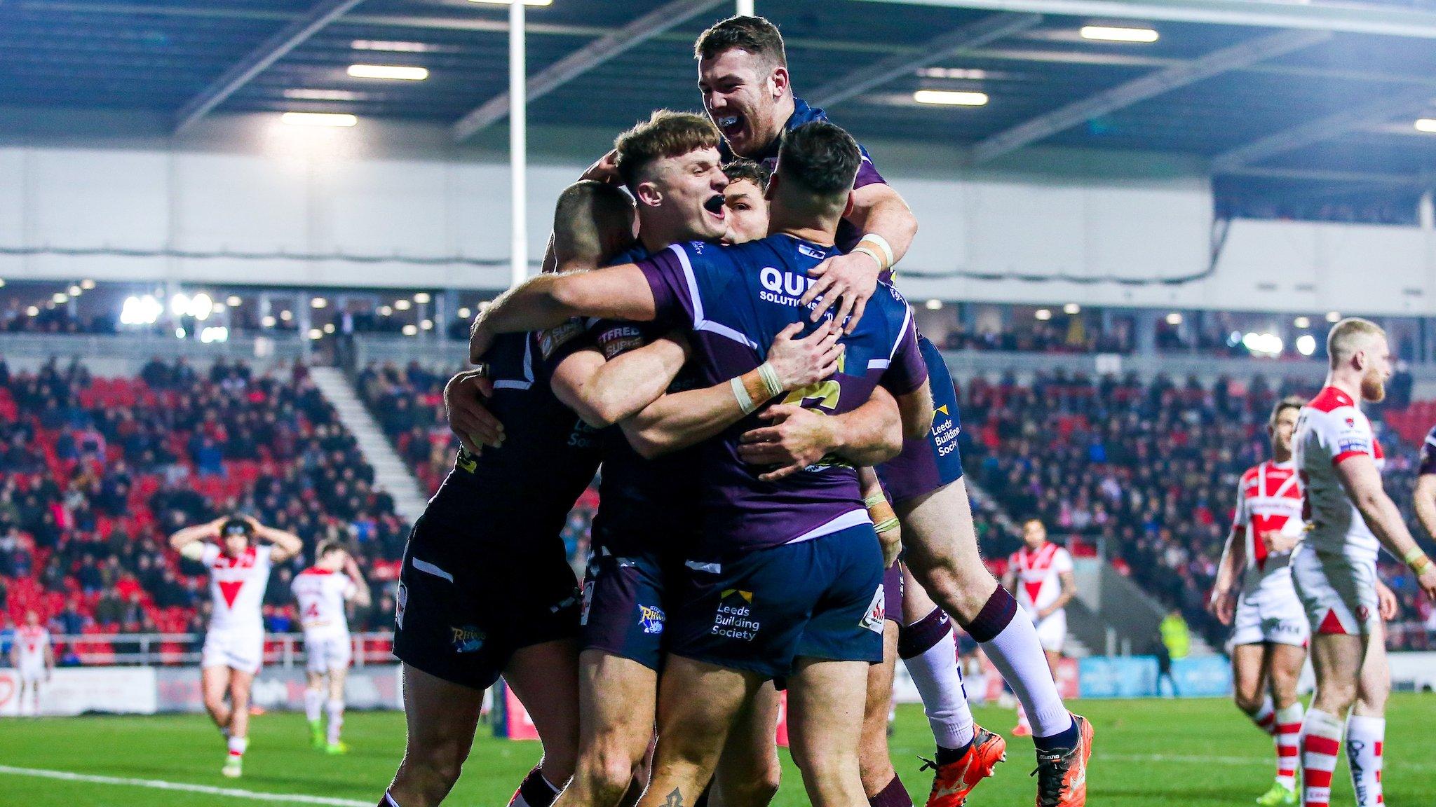 Ash Handley celebrates with his Leeds teammates after scoring against St Helens