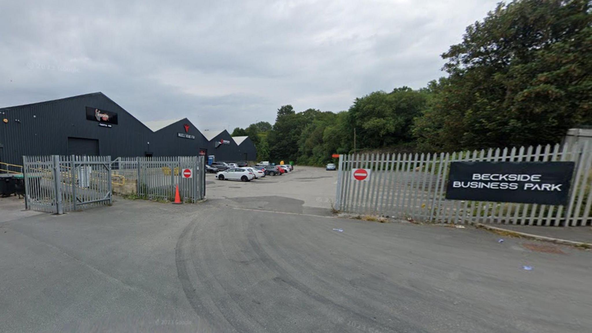 An exterior shot of a unit within a business park surrounded by metal gates