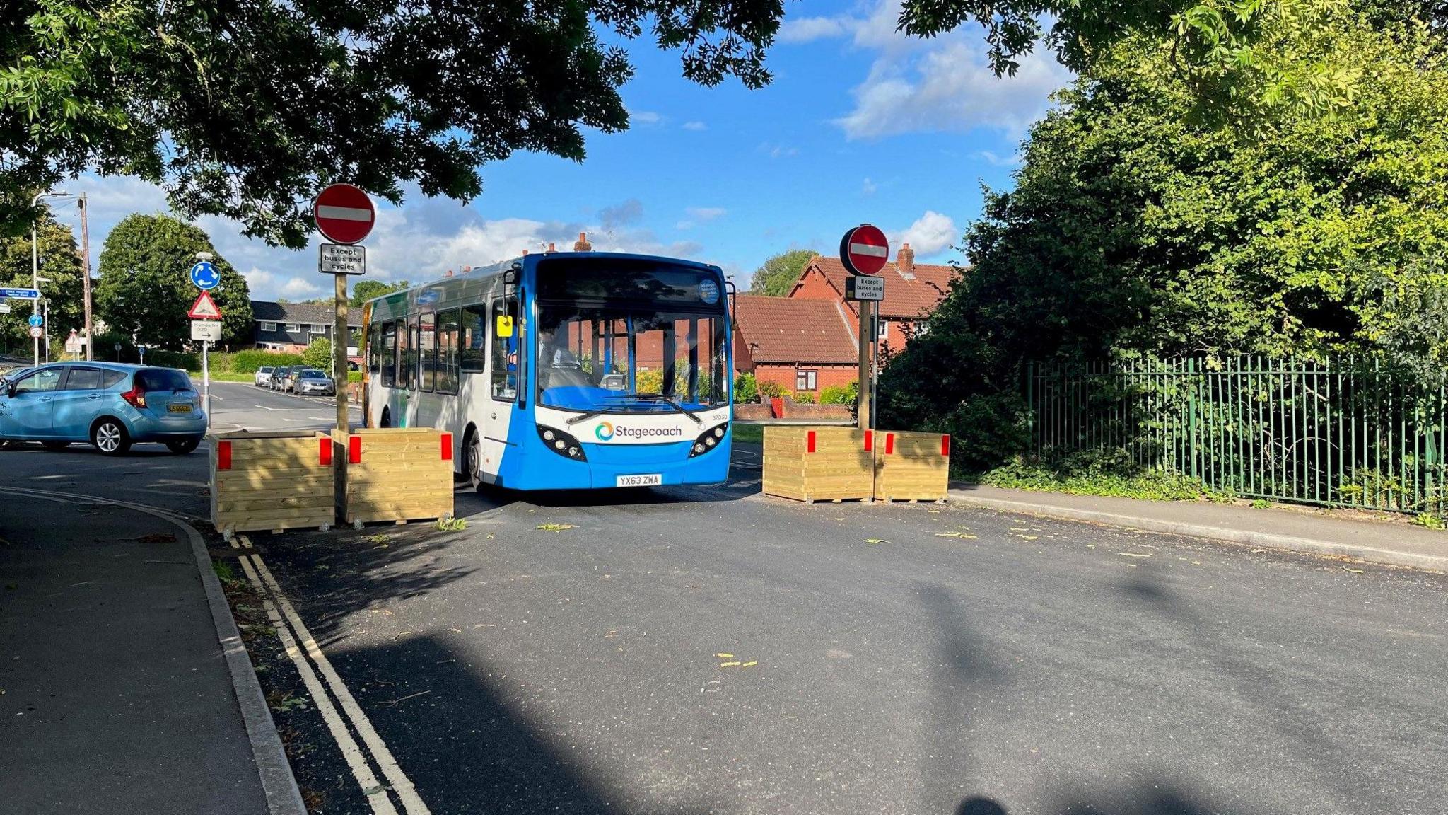 A bus passes through a bus gate in a Exeter low traffic neighbourhood