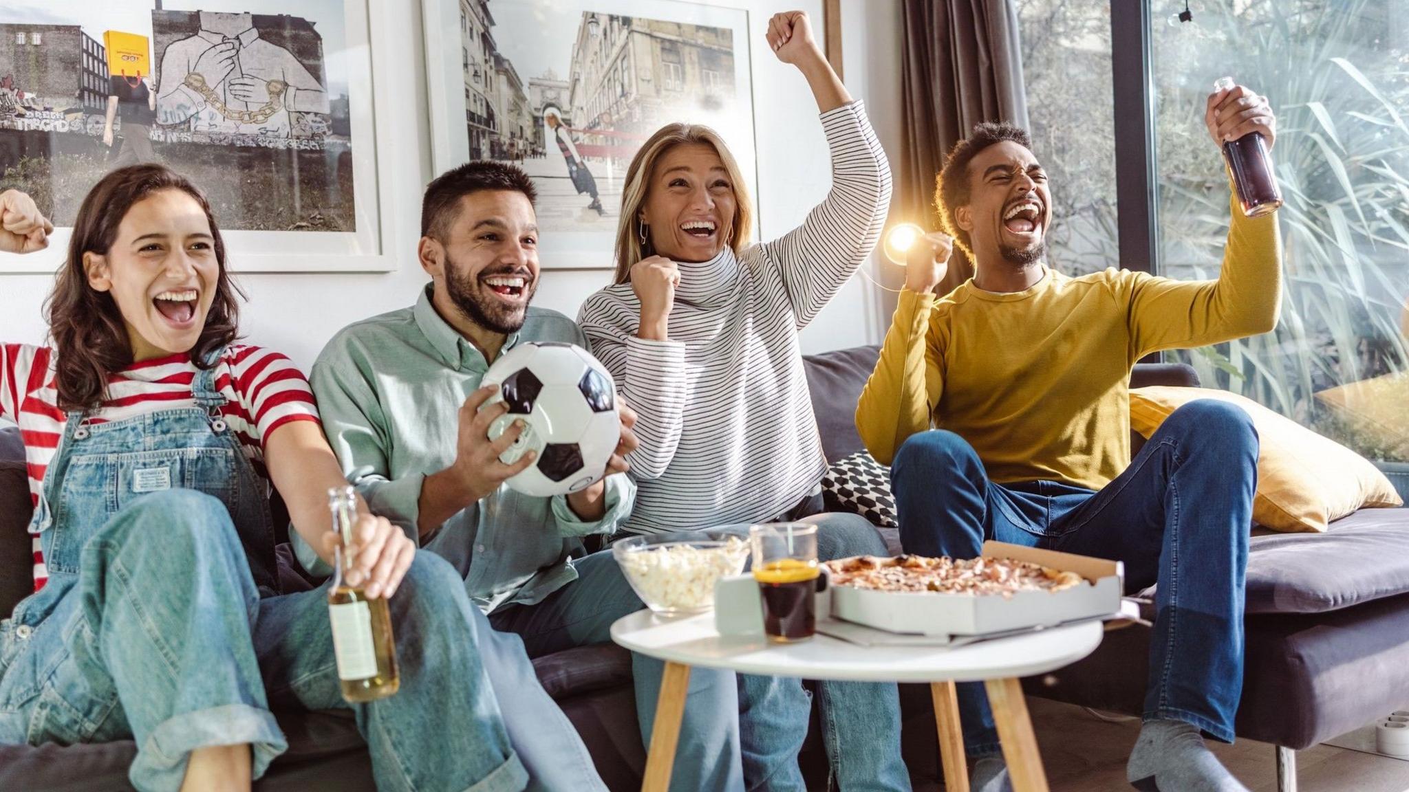 Excited sports fans cheering for sport team - stock photo