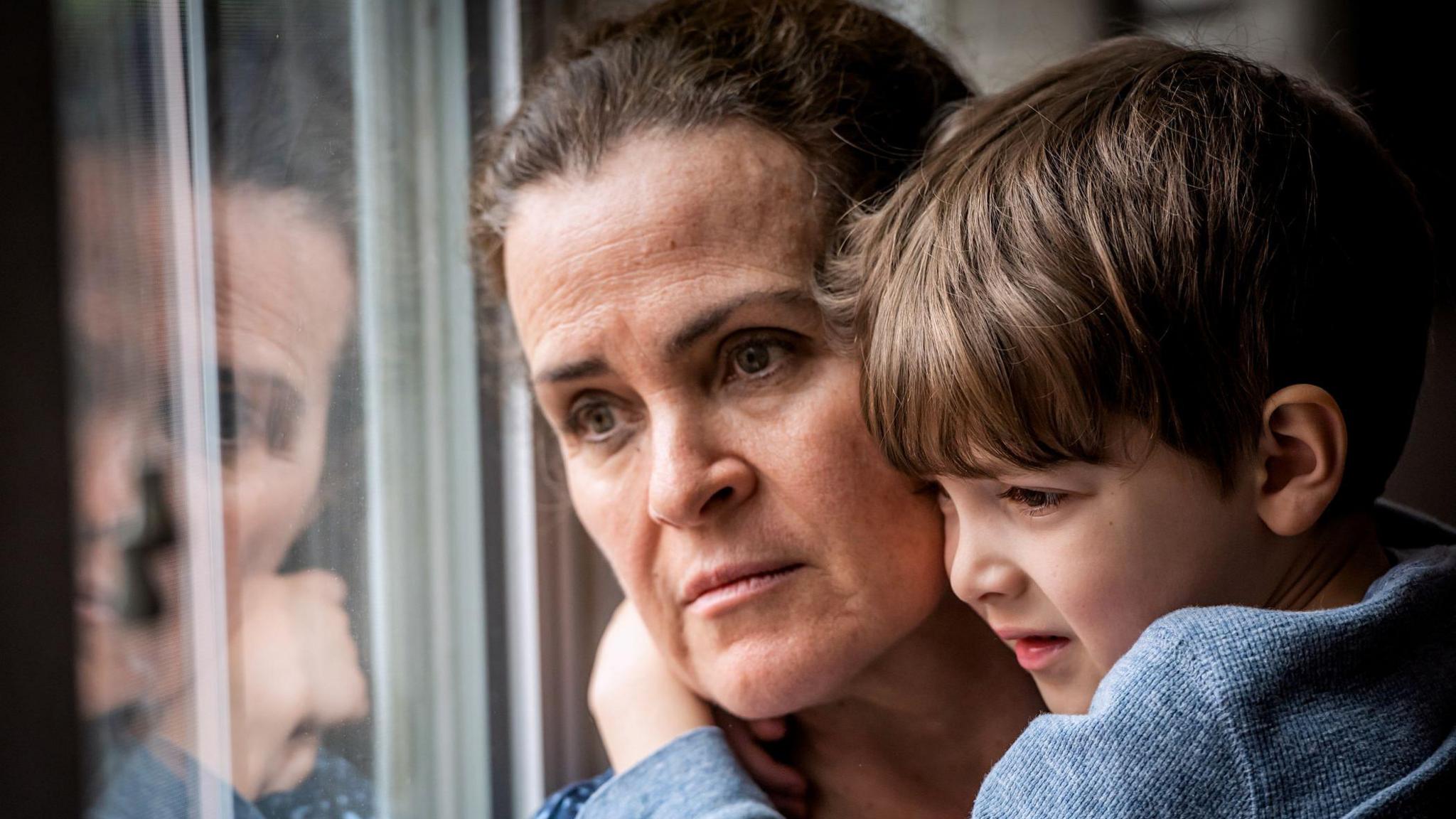 A woman and son looking worried