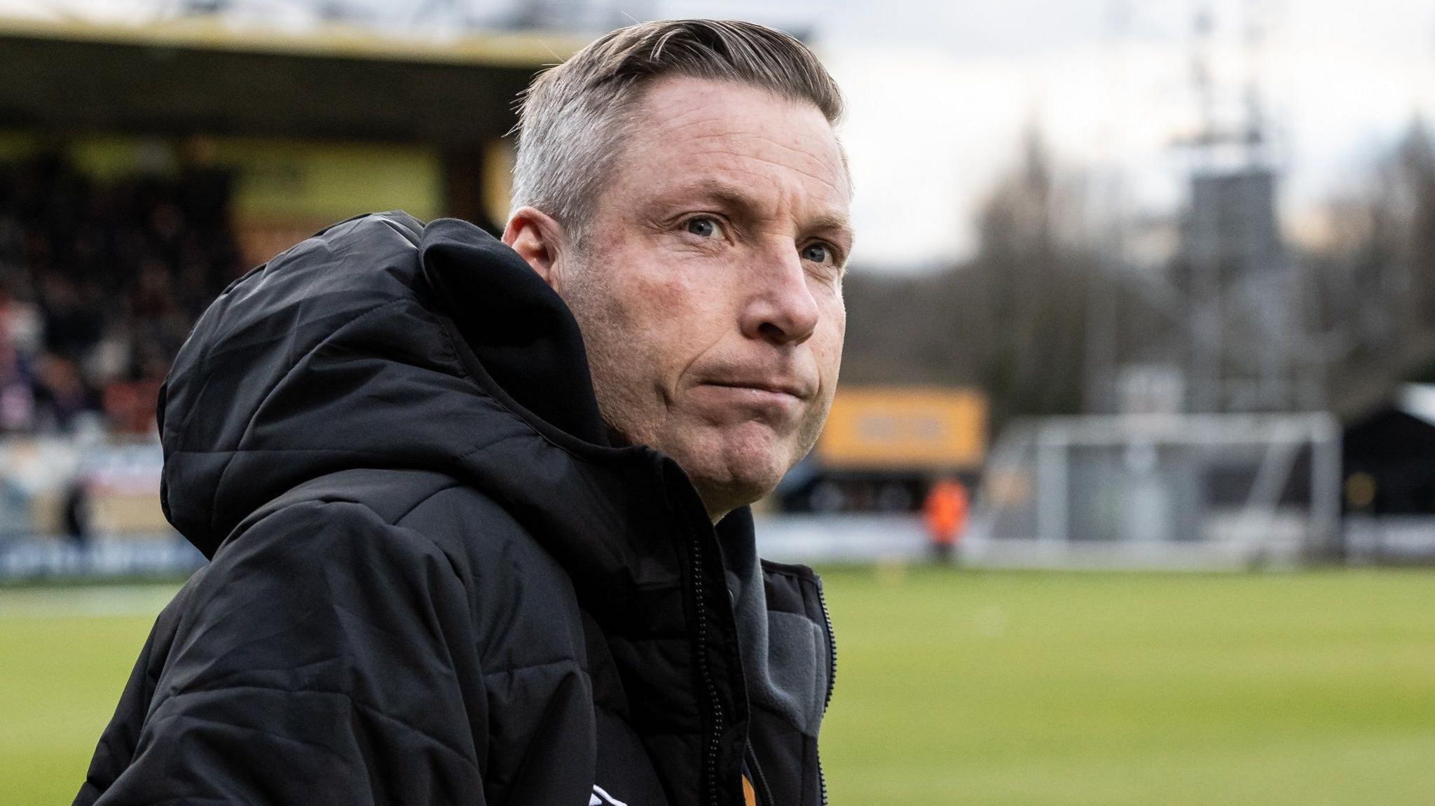 Neil Harris watching Cambridge United play against Blackpool