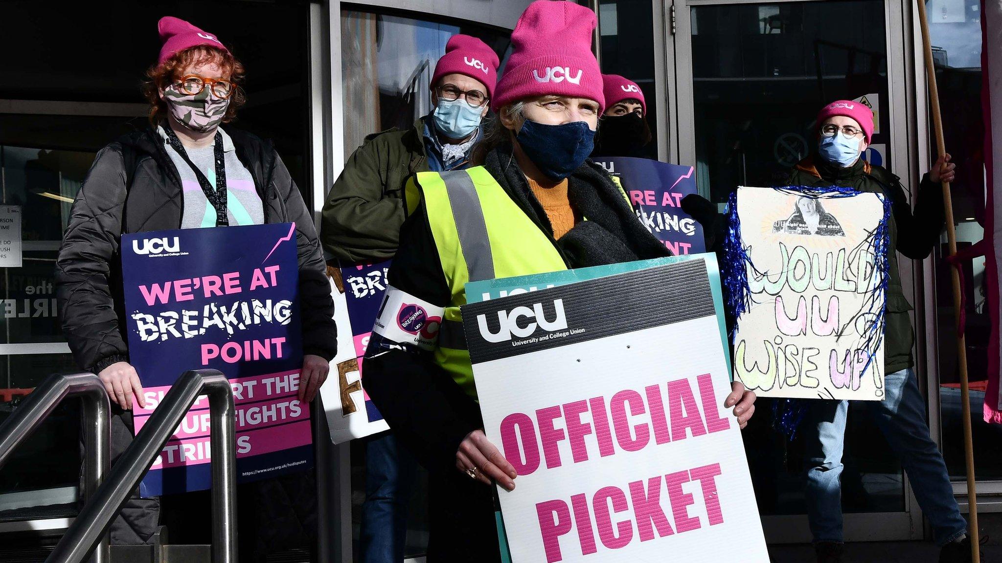 University staff holding placards