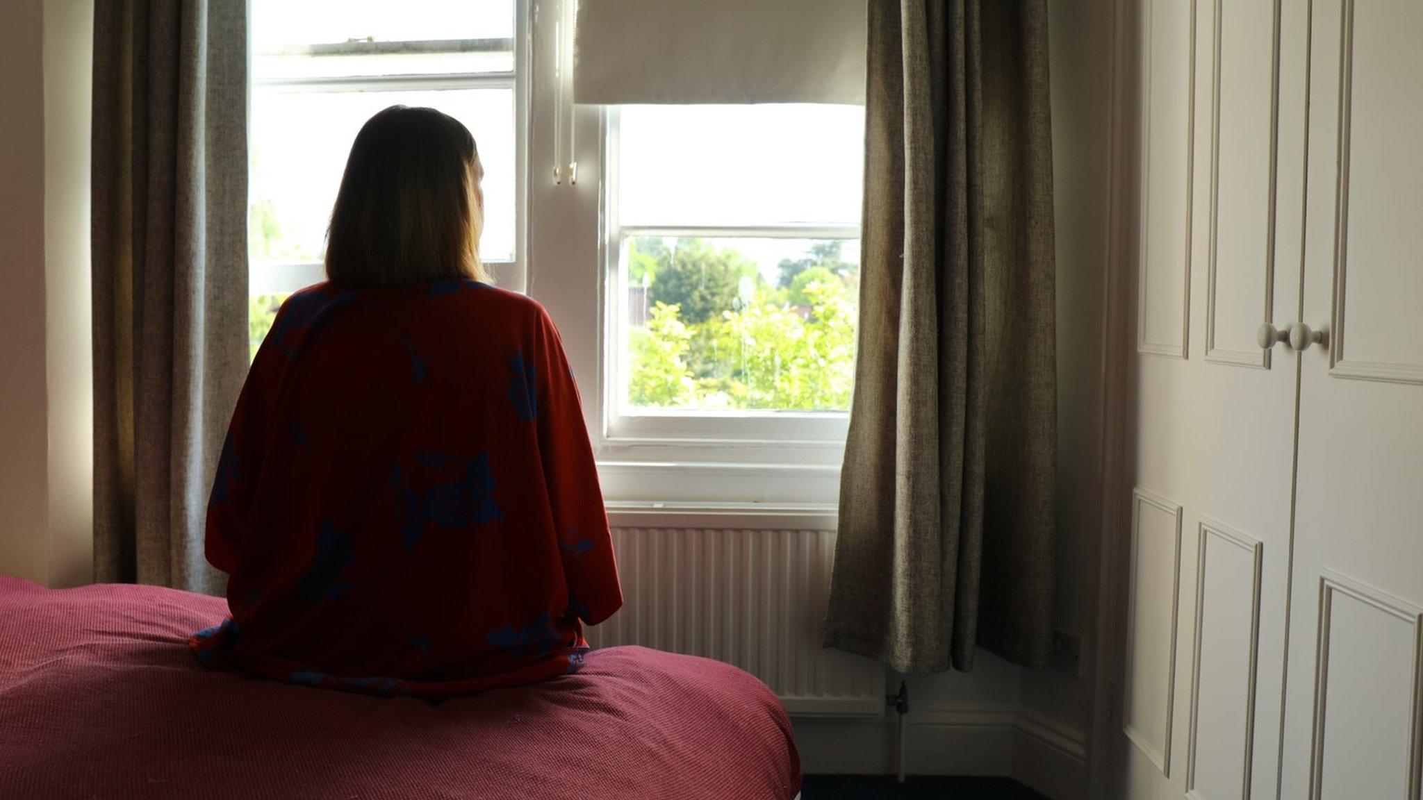 Person sitting in a room alone