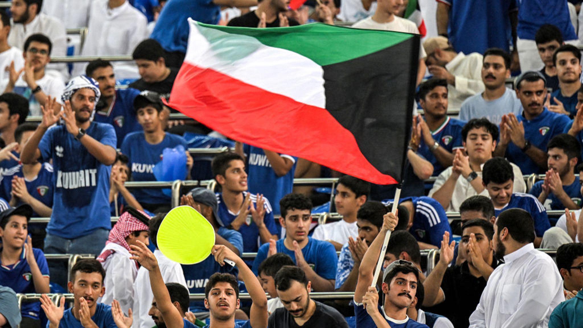 Fans fly a Kuwait flag inside the Jaber Al-Ahmad International Stadium during Tuesday's World Cup qualifier against Iraq