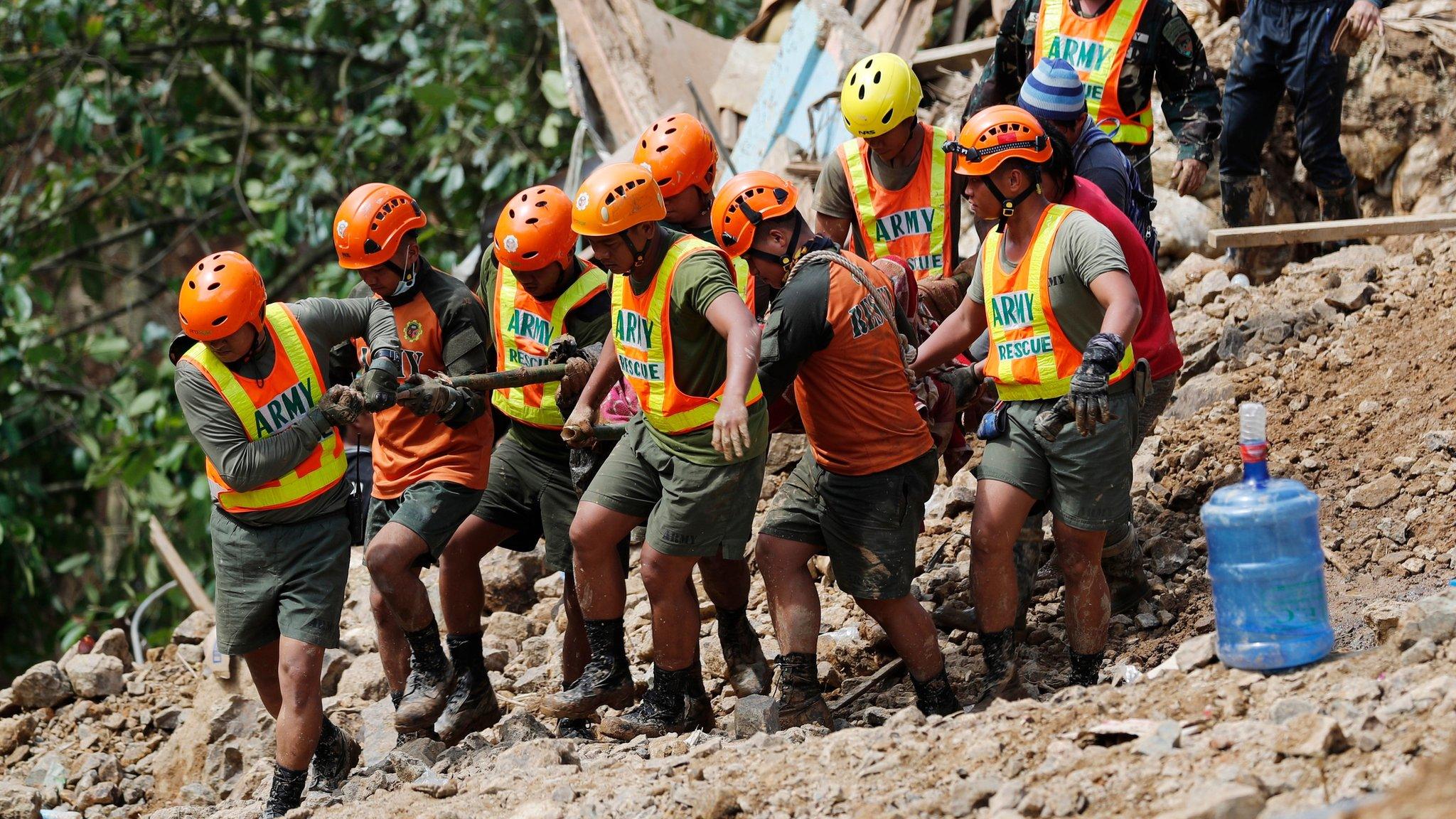 Rescue volunteers carry the body of a landslide victim caused by Typhoon Mangkhut during rescue efforts in Ucab village, Itogon town, Benguet Province, Philippines, 17 September 2018