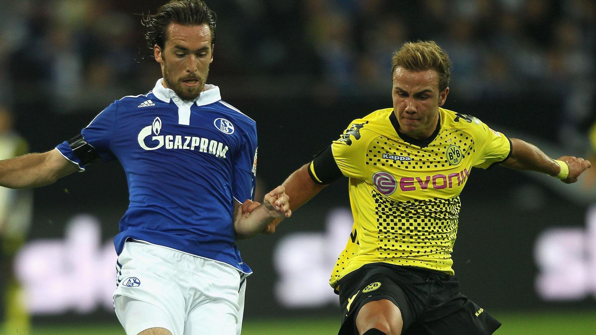 Schalke's Christian Fuchs battles with Borussia Dortmund's Mario Goetze