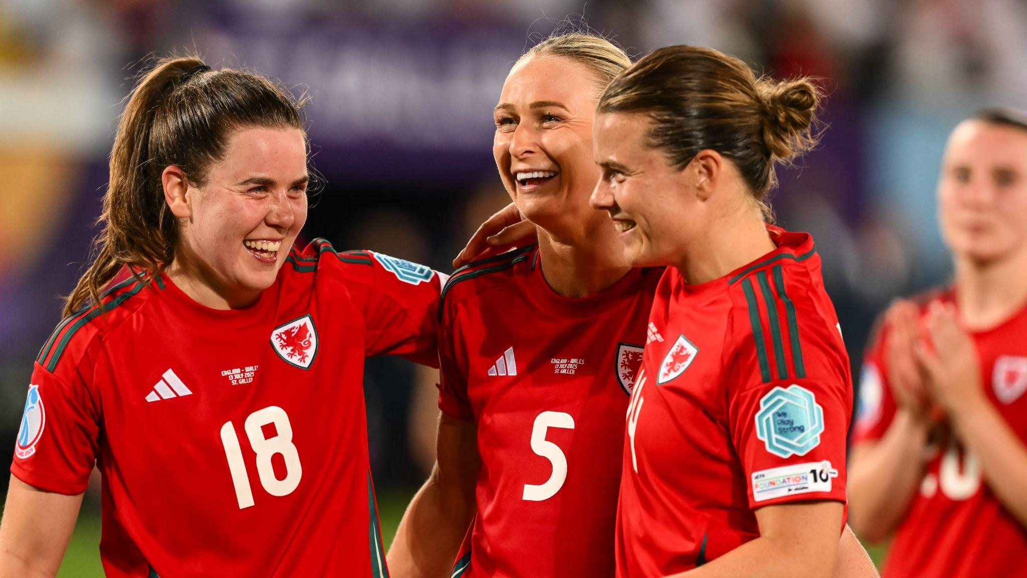 Wales’ Esther Morgan, Rhiannon Roberts and Hayley Ladd smiling after the Euro 2025 Group D match against England