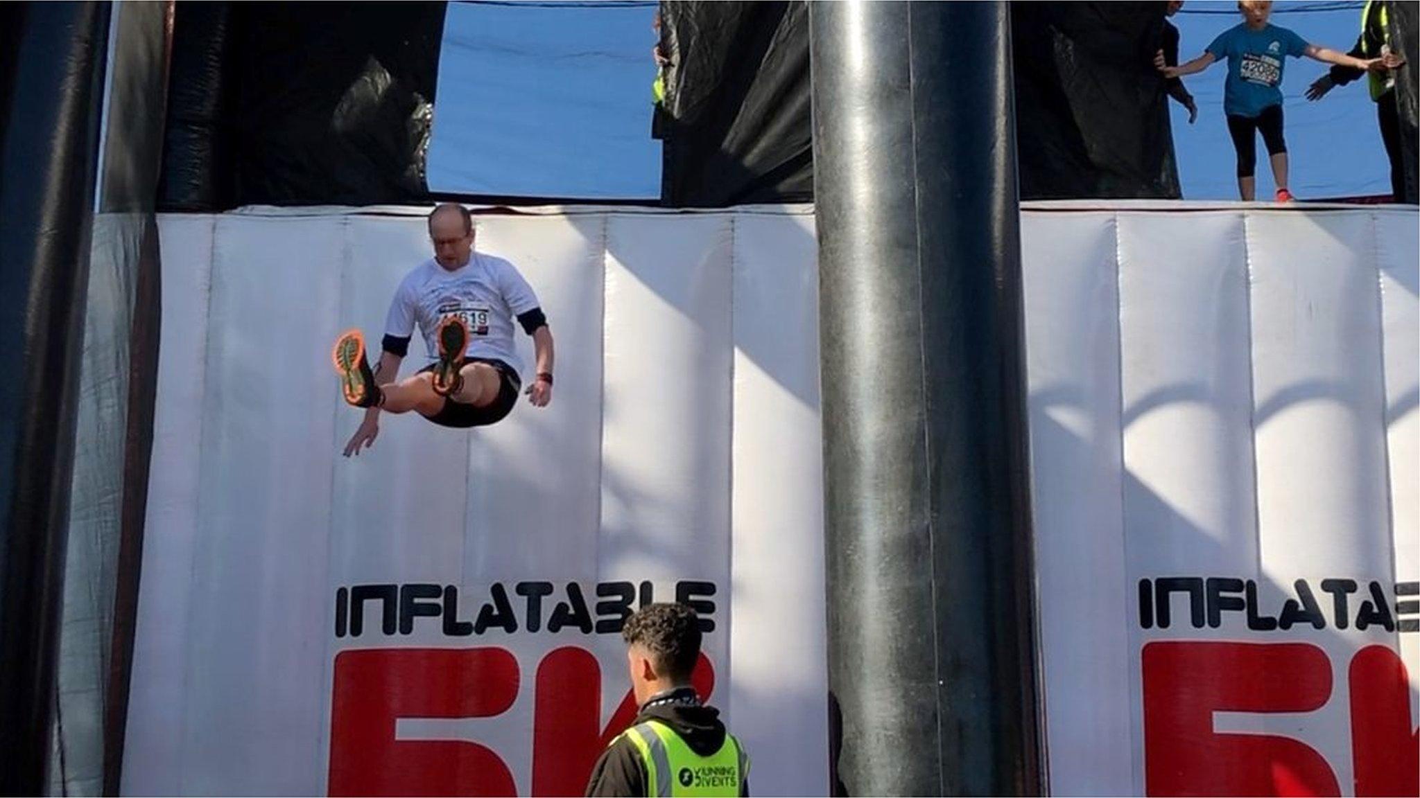 Person jumping off an inflatable wall