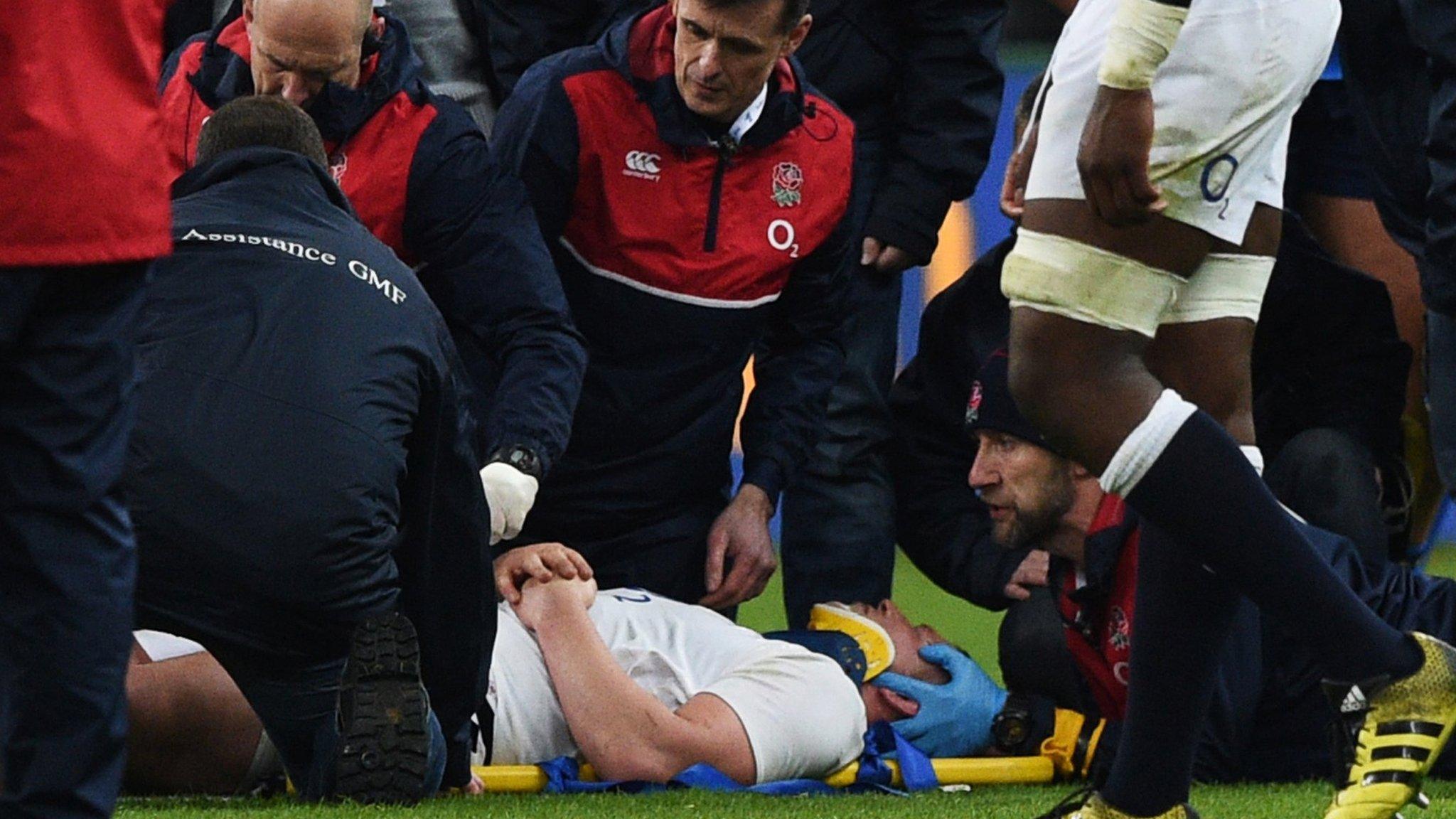 England captain Dylan Hartley receives treatment on a head injury