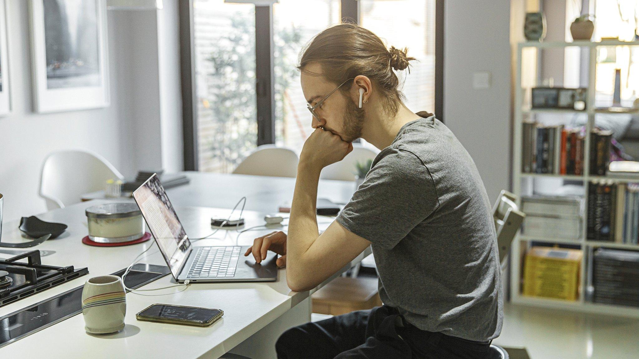 Man working from home on a laptop.