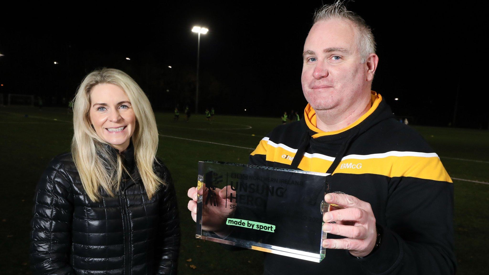 Brian McGuigan received the BBC Sport NI Unsung Hero award from Nicola McCarthy