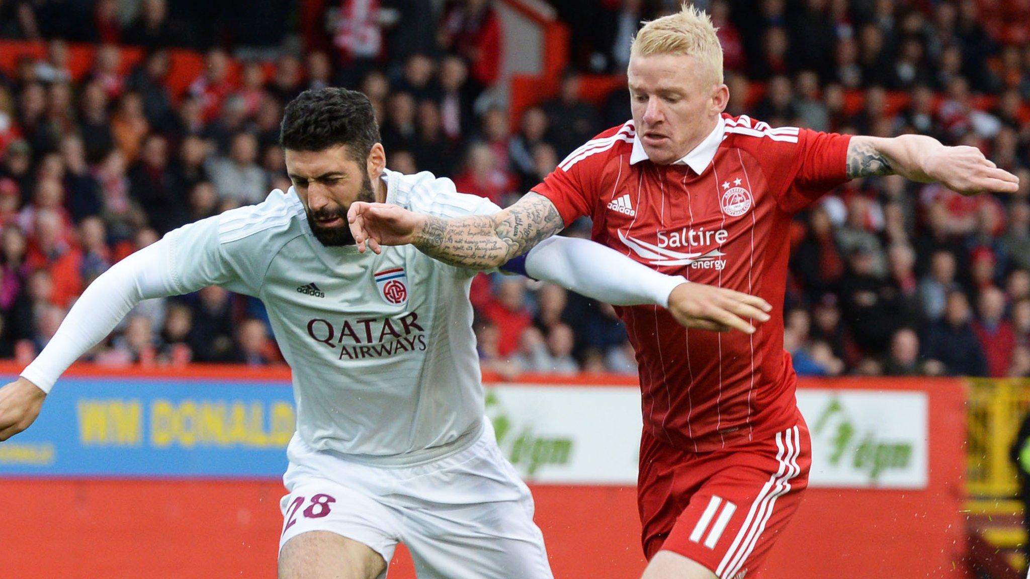 Aberdeen's Johnny Hayes challanges Fola Esch captain Julien Klein for the ball