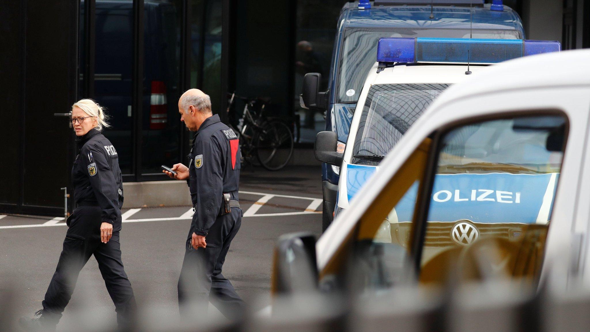 Police officers at Deutsche Bank headquarters