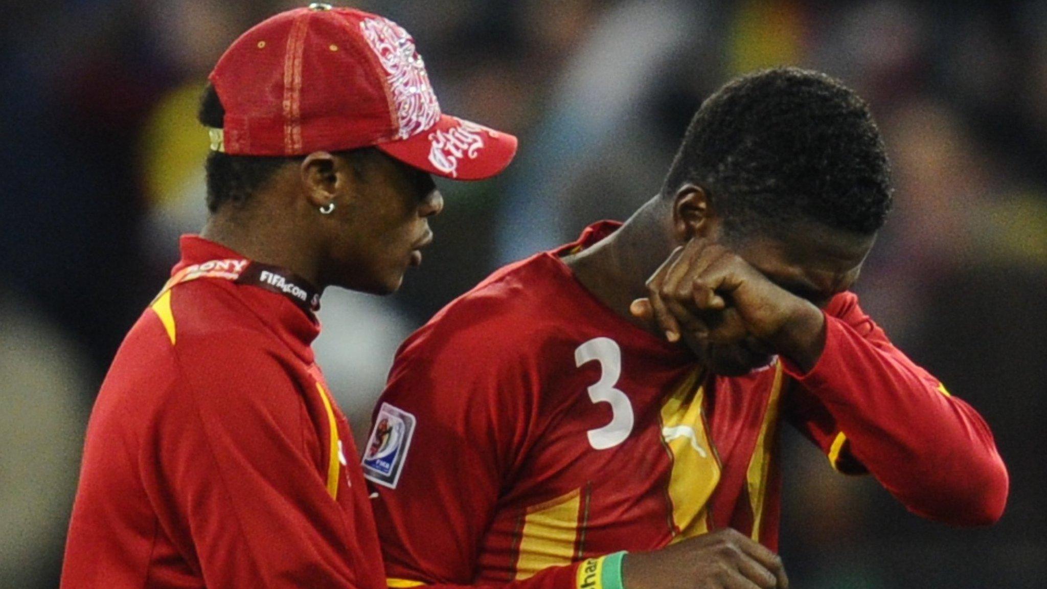 Asamoah Gyan is consoled after Ghana's quarter-final defeat to Uruguay at the 2010 World Cup