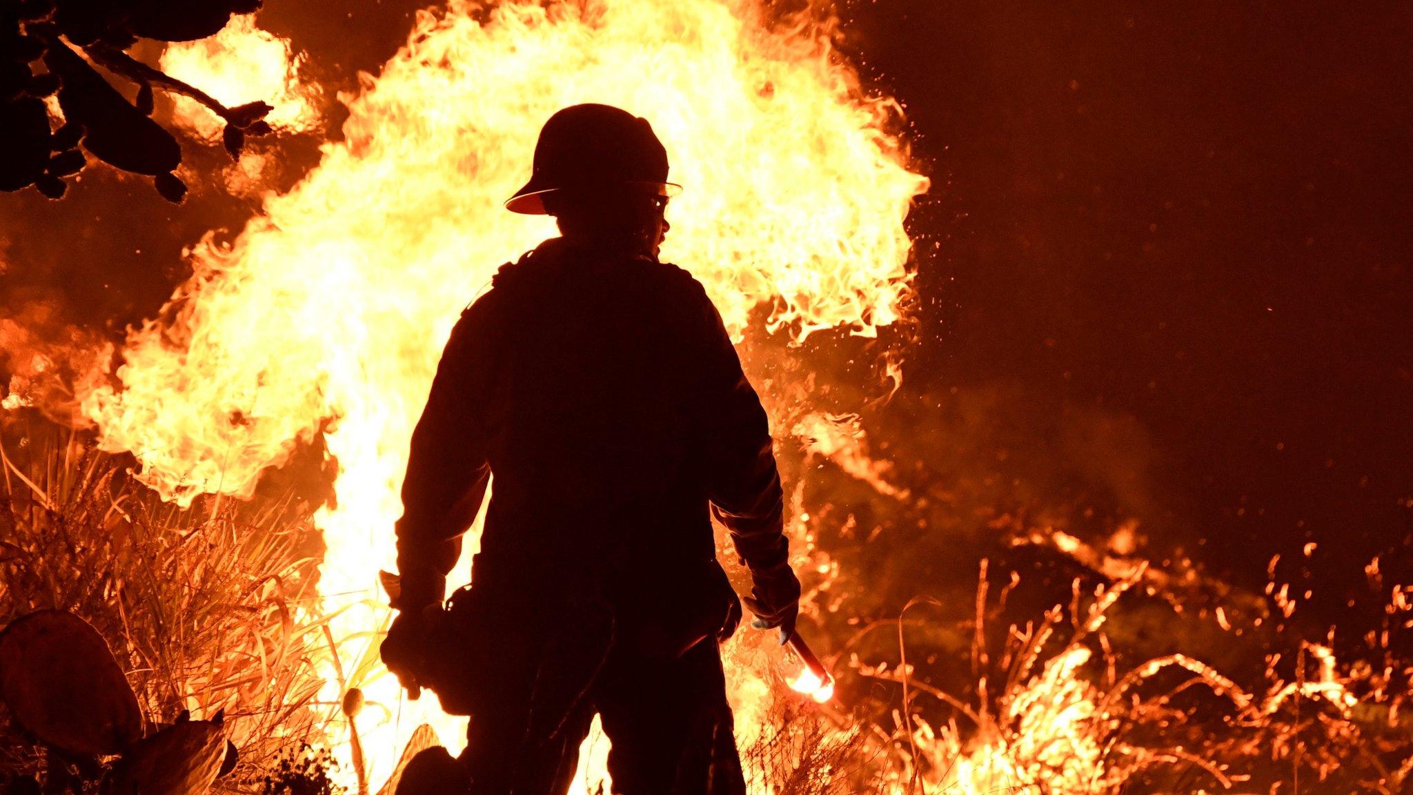 Firefighters battle a Santa Ana wind-driven brush fire called the Thomas Fire near Ventura, California, December 5, 2017.