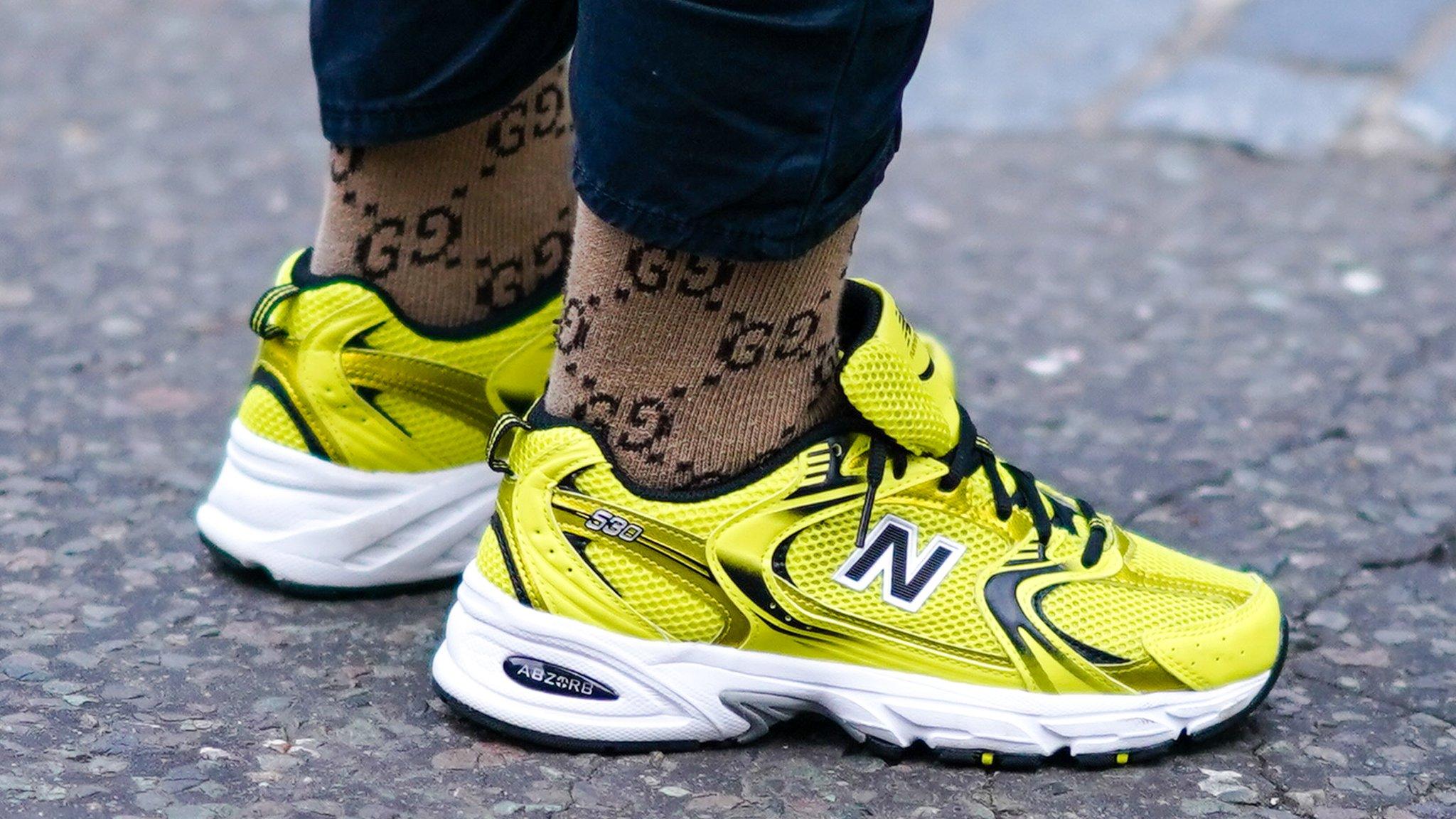 Close up of someone wearing yellow New Balance trainers