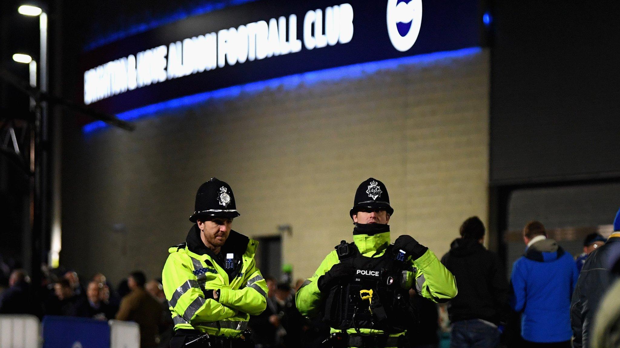 Police stand outside Brighton's Amex Stadium