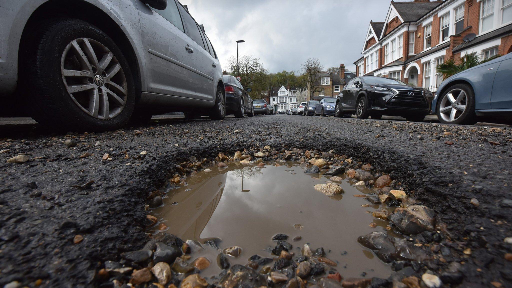 A pothole in a busy urban street