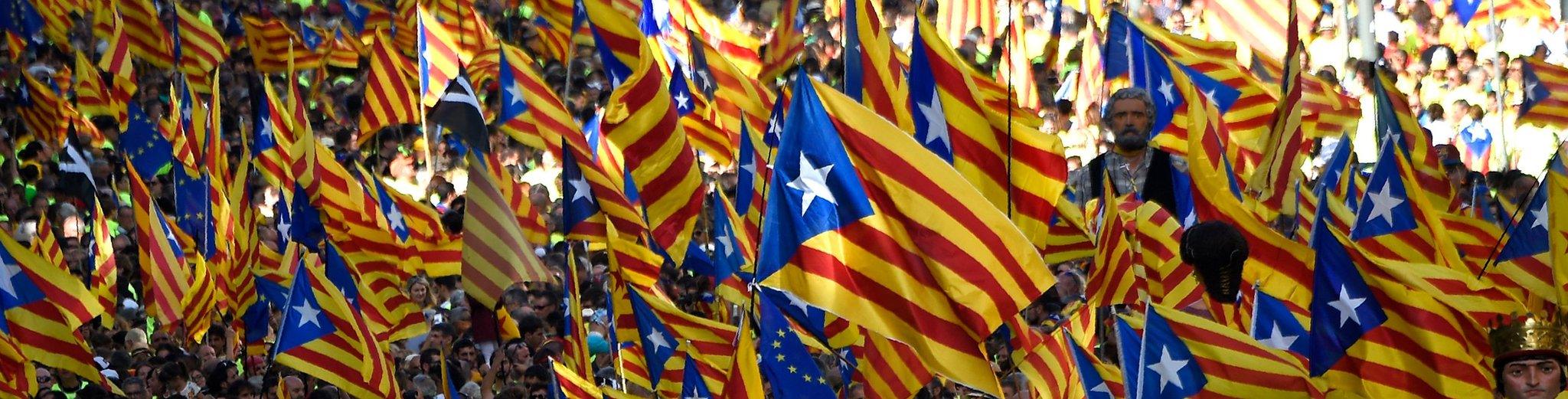 People wave "Esteladas" (pro-independence Catalan flags) as they gather during a pro-independence demonstration, on September 11, 2017 in Barcelona