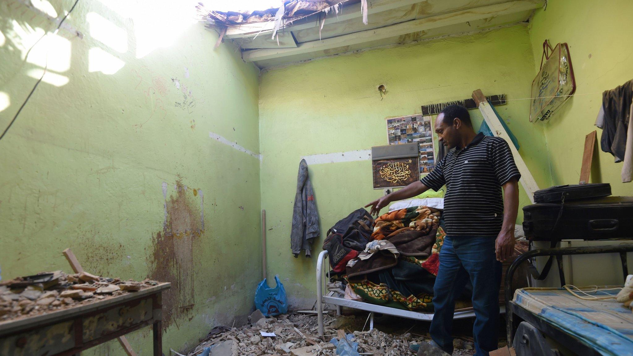 A man shows the damage caused to a home in Riyadh that was hit by a piece of shrapnel from a ballistic missile fired by Yemeni Houthi rebels (26 March 2018)