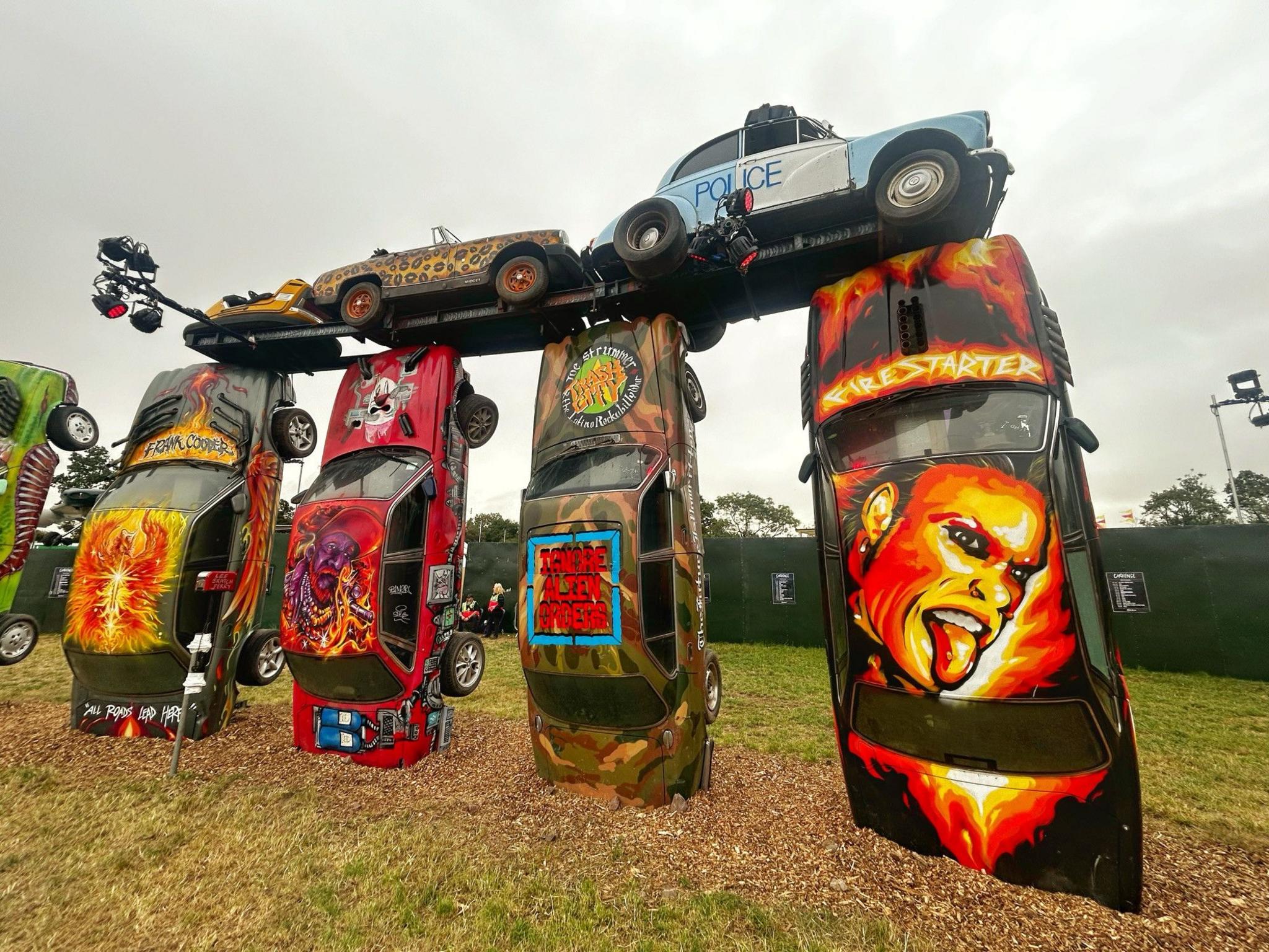 A Keith Flint mural is seen on one of the cars at Glastonbury's Carhenge monument