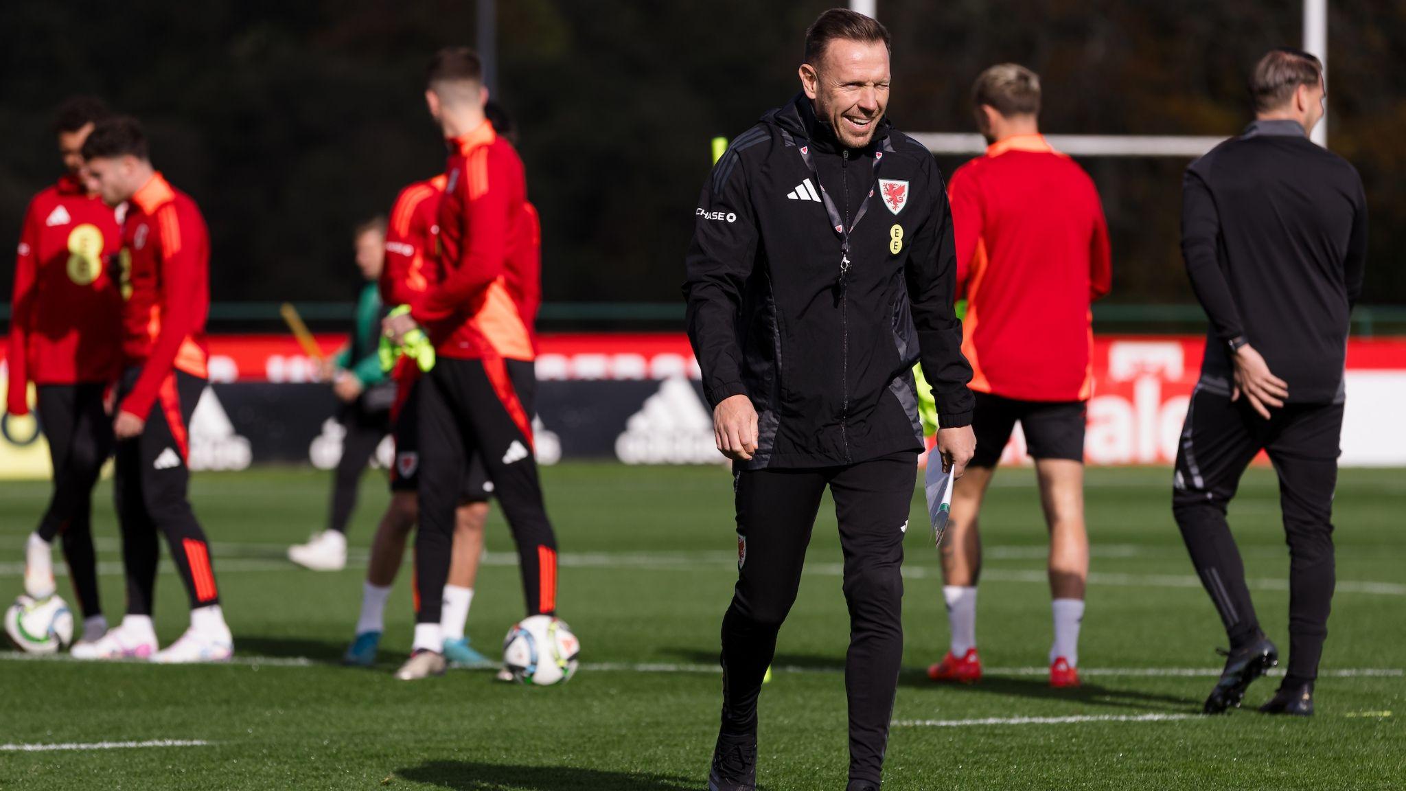 Craig Bellamy smiles at a Wales training session