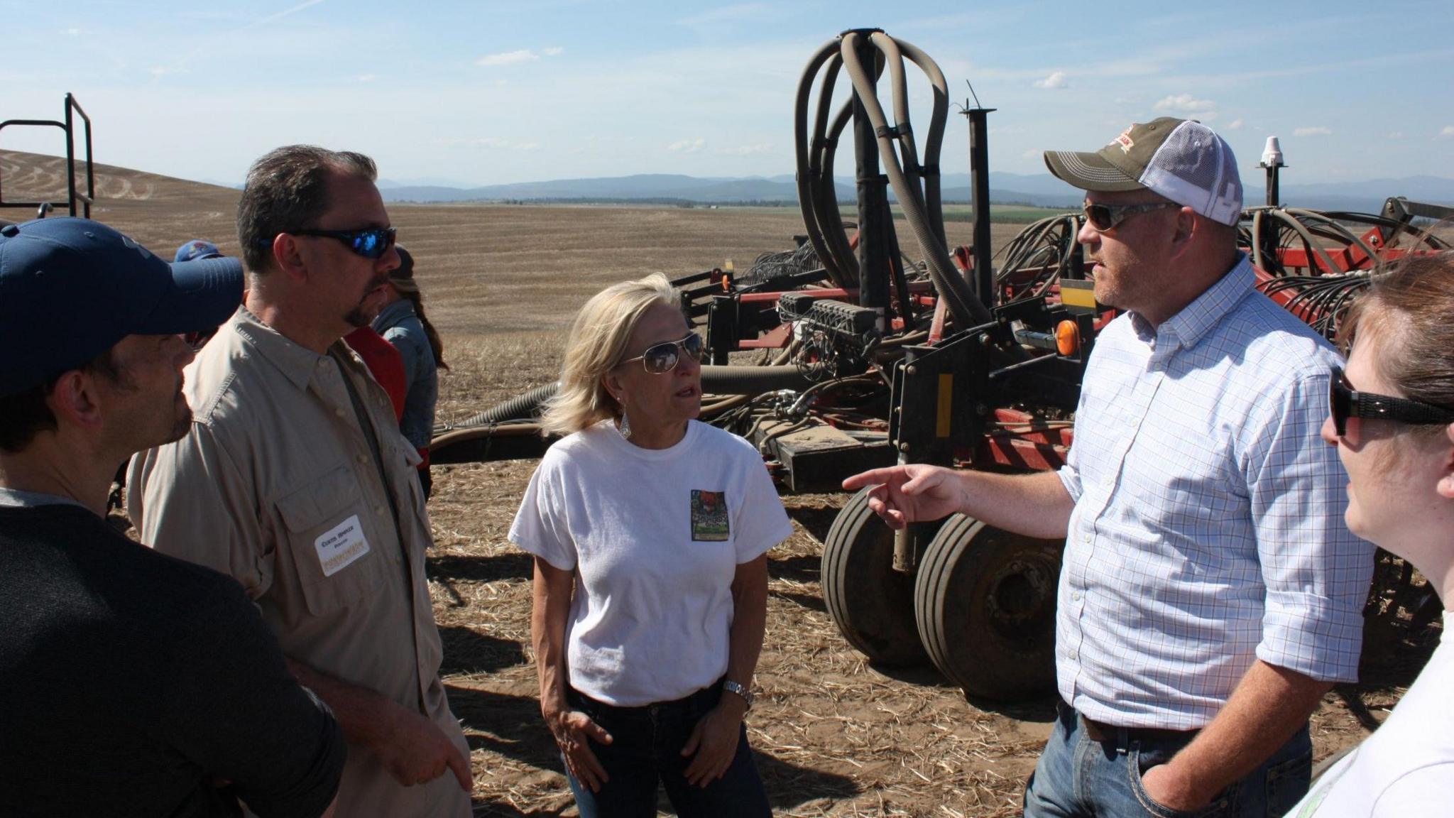 Jeremy Bunch, second right, talking to farmers