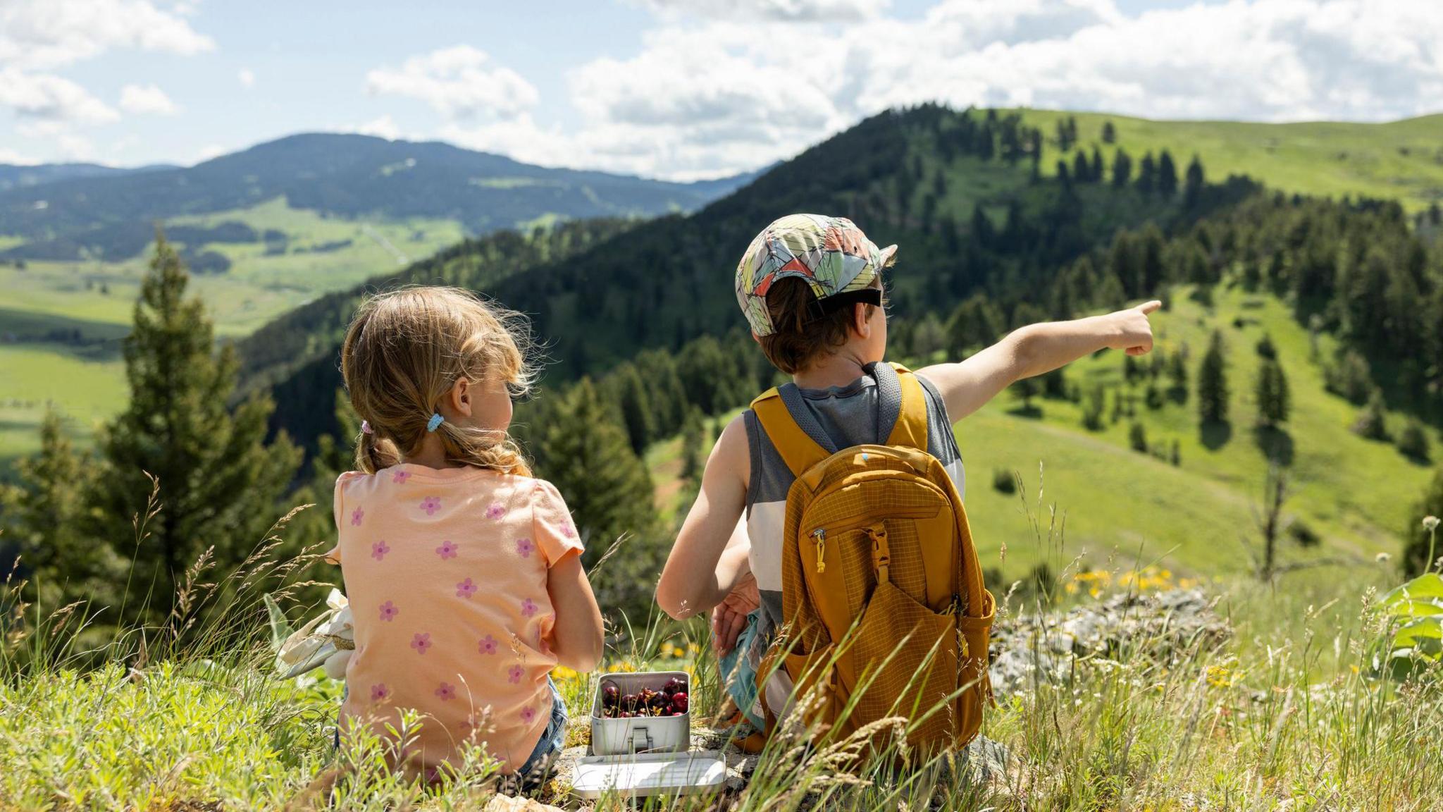 Two kids hiking a trail