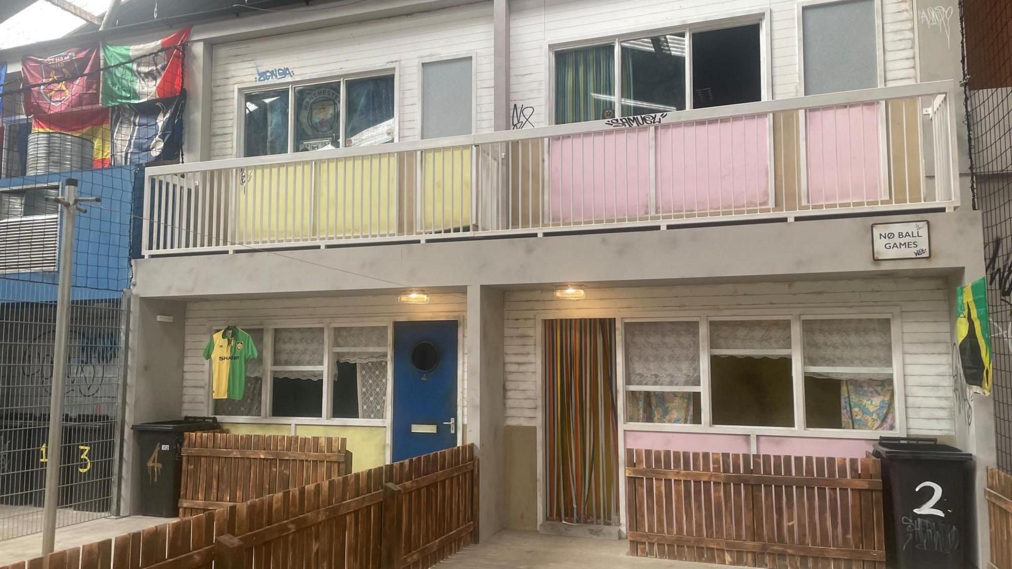 Two 1960s maisonettes with wooden fences