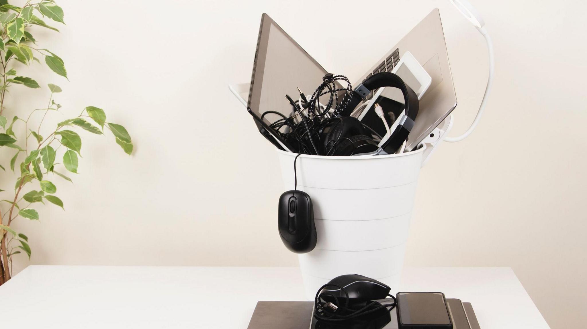 Electrical items like a mouse and headphones in the bin