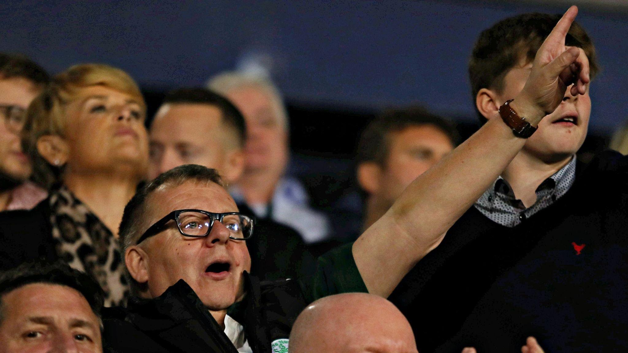 The New Saints owner Mike Harris points in the crowd at Shrewsbury's Croud Meadow